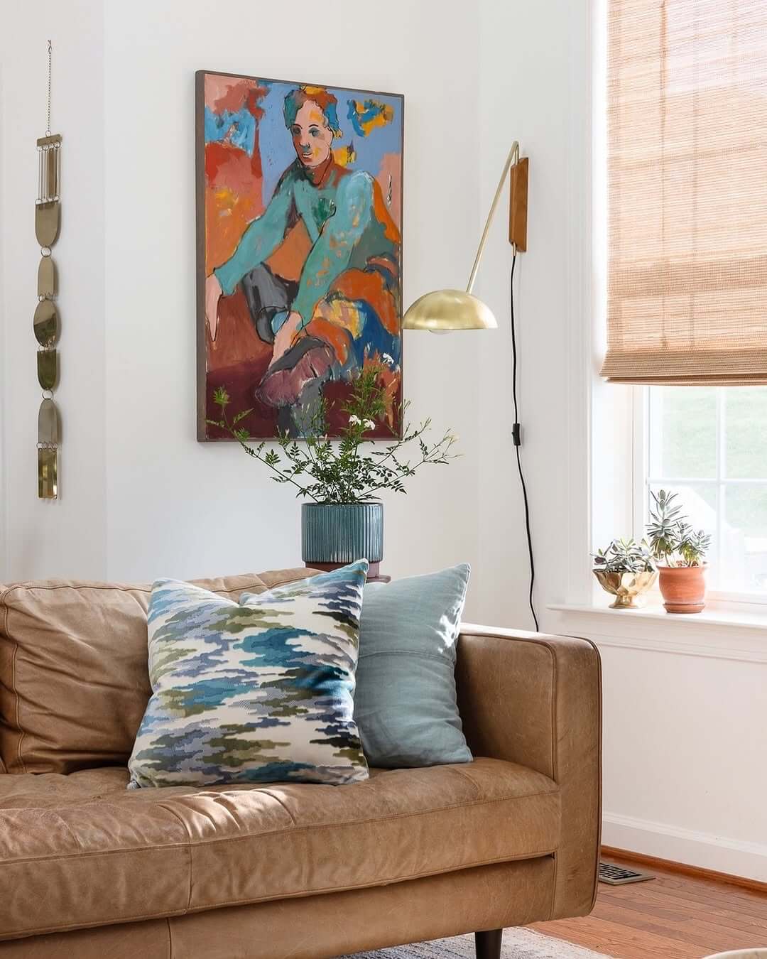 Adjustable Brass Wall Sconce Highlights Artwork