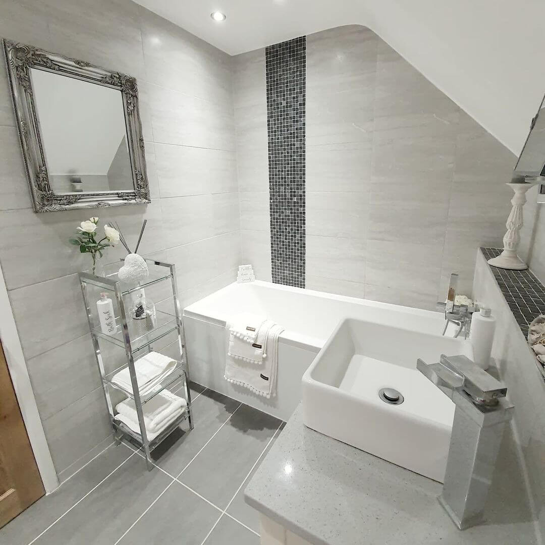 Ornate Silver Mirror Frames a Small Bathroom