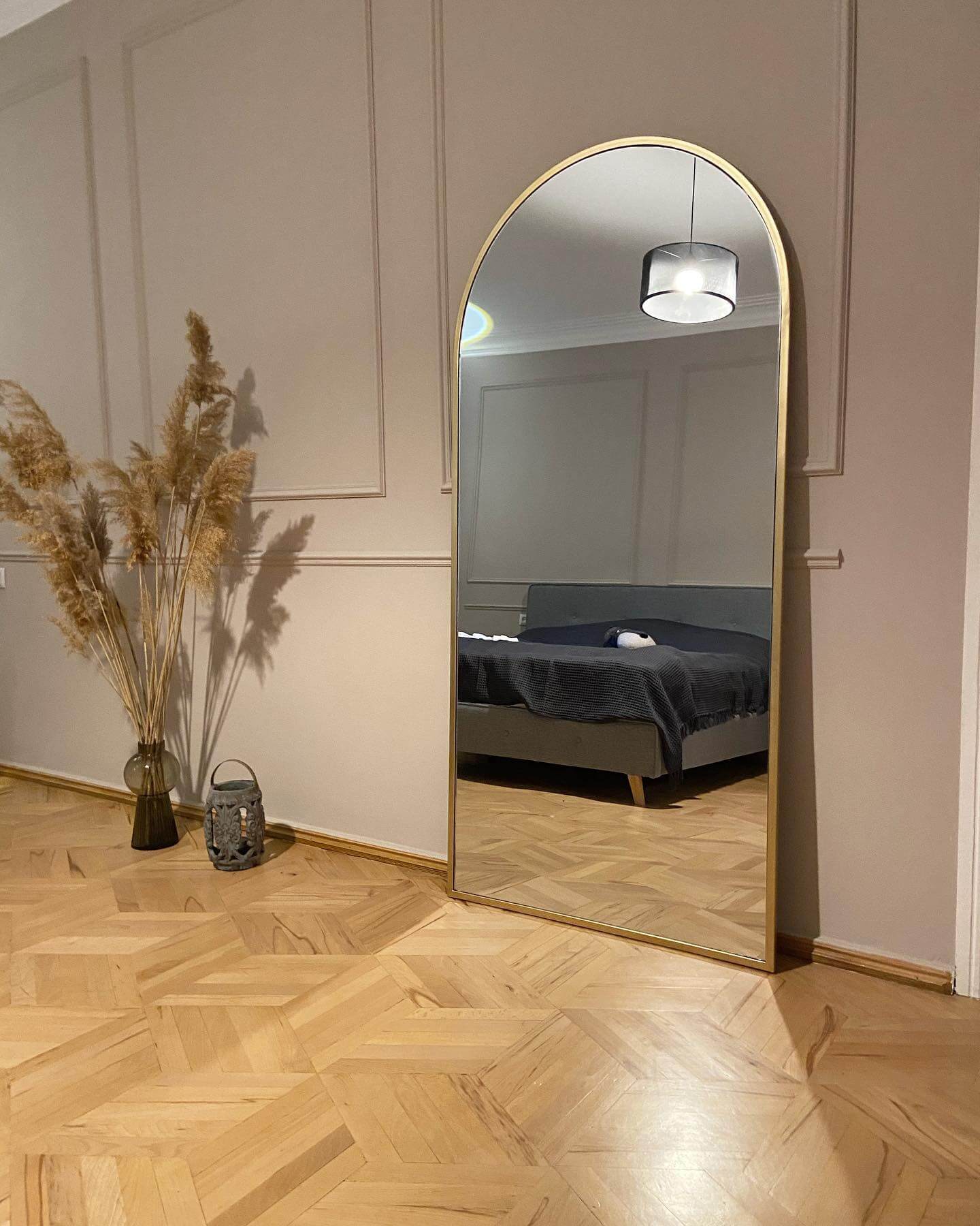 Soften Paneled Walls with a Tall Arched Mirror
