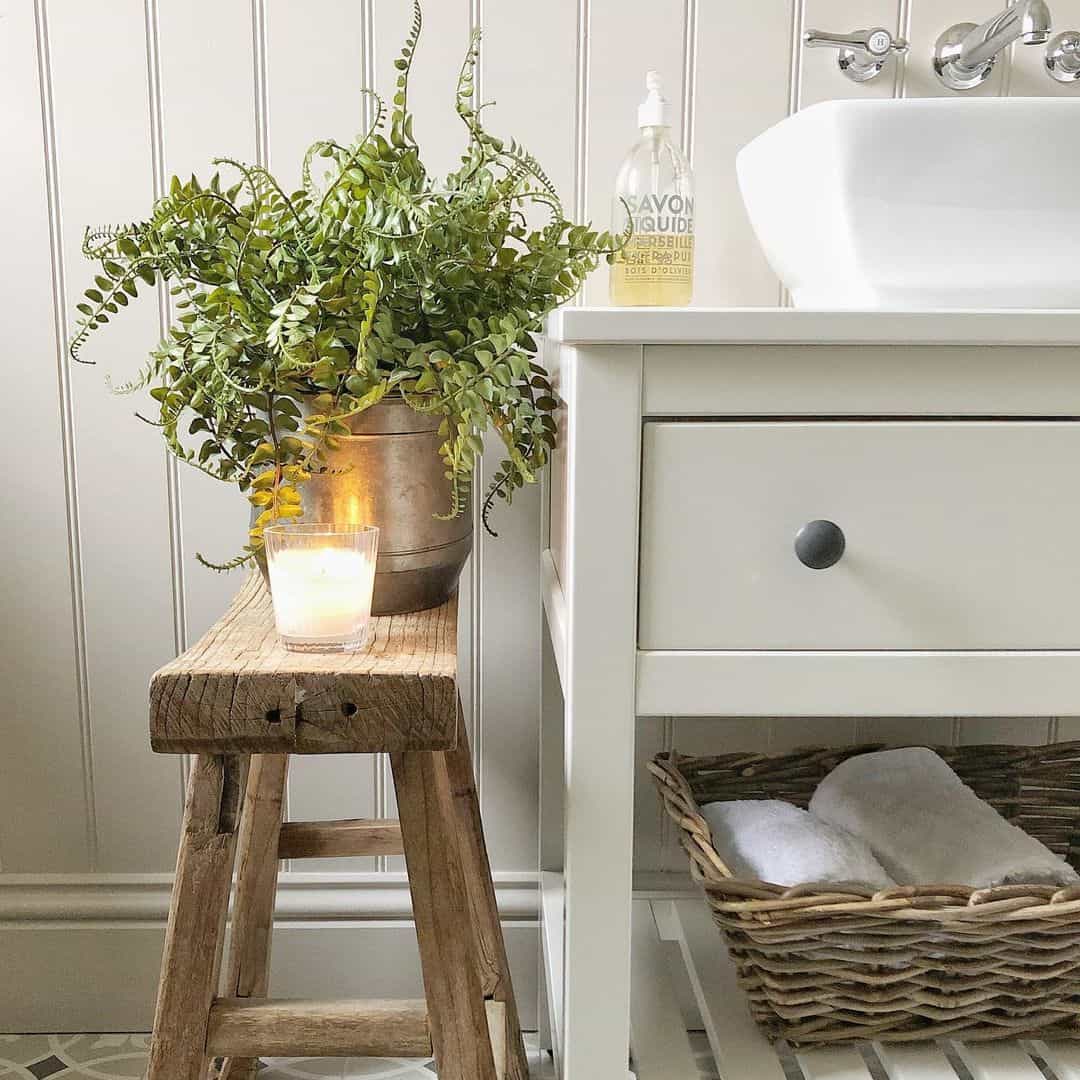 Rustic Wooden Stool Holds a Potted Plant and Candle