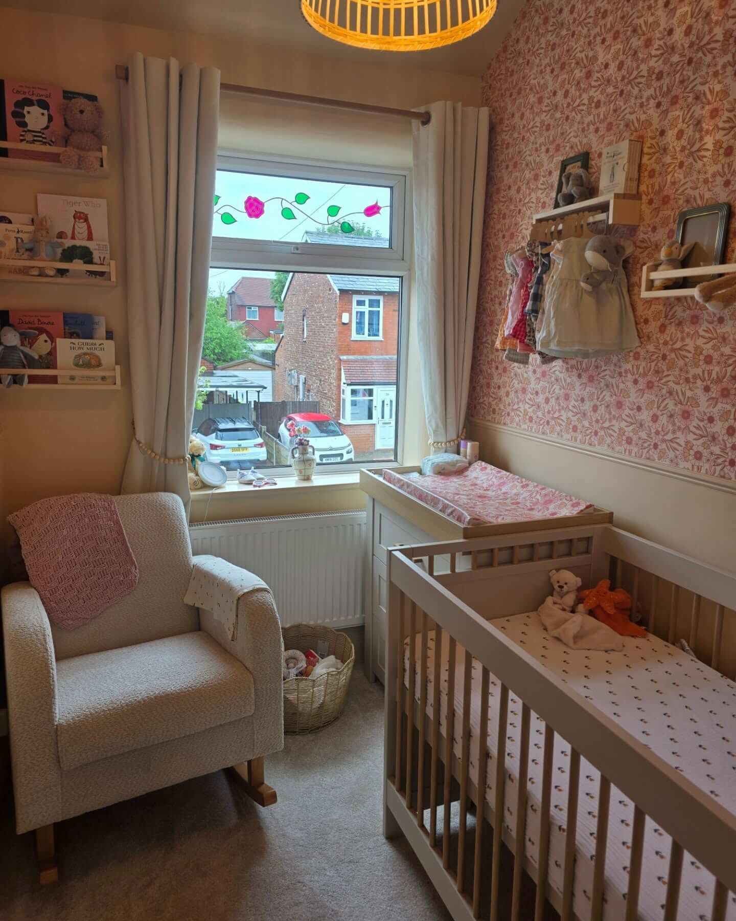 Pink floral wallpaper adds a charming accent wall