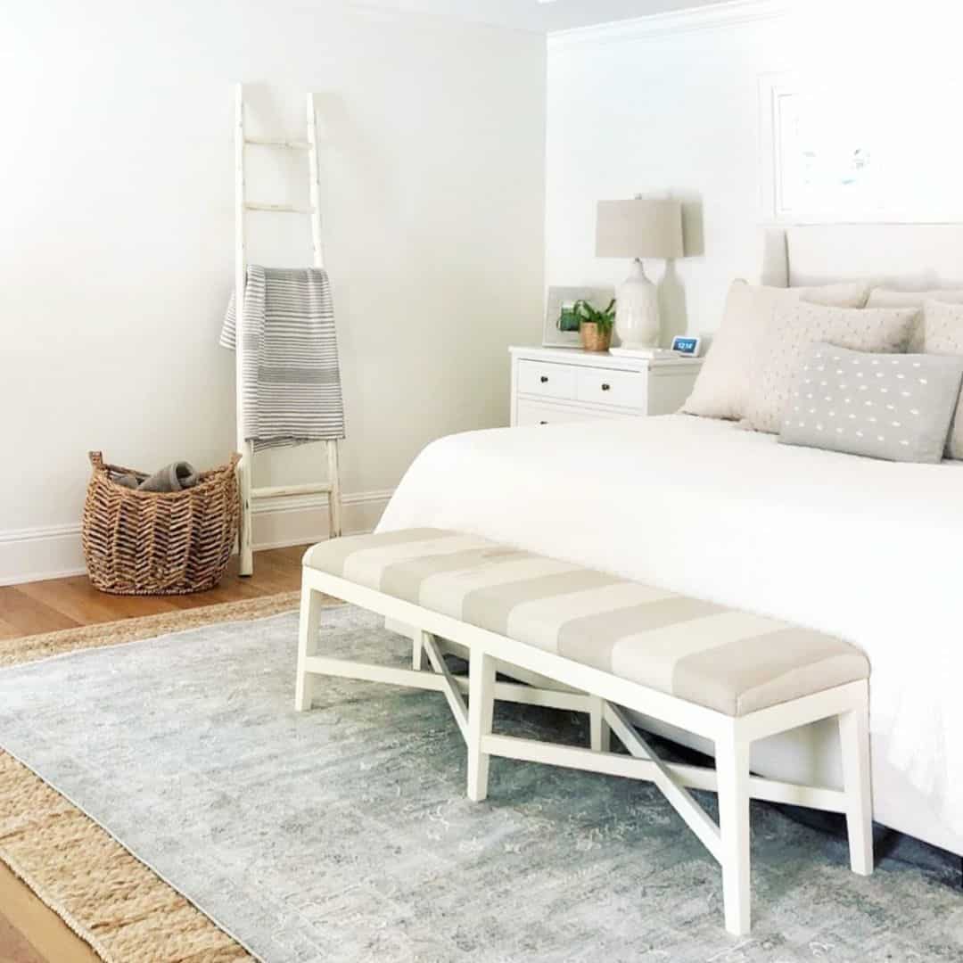White Ladder Shelf Holds Cozy Throws and Baskets