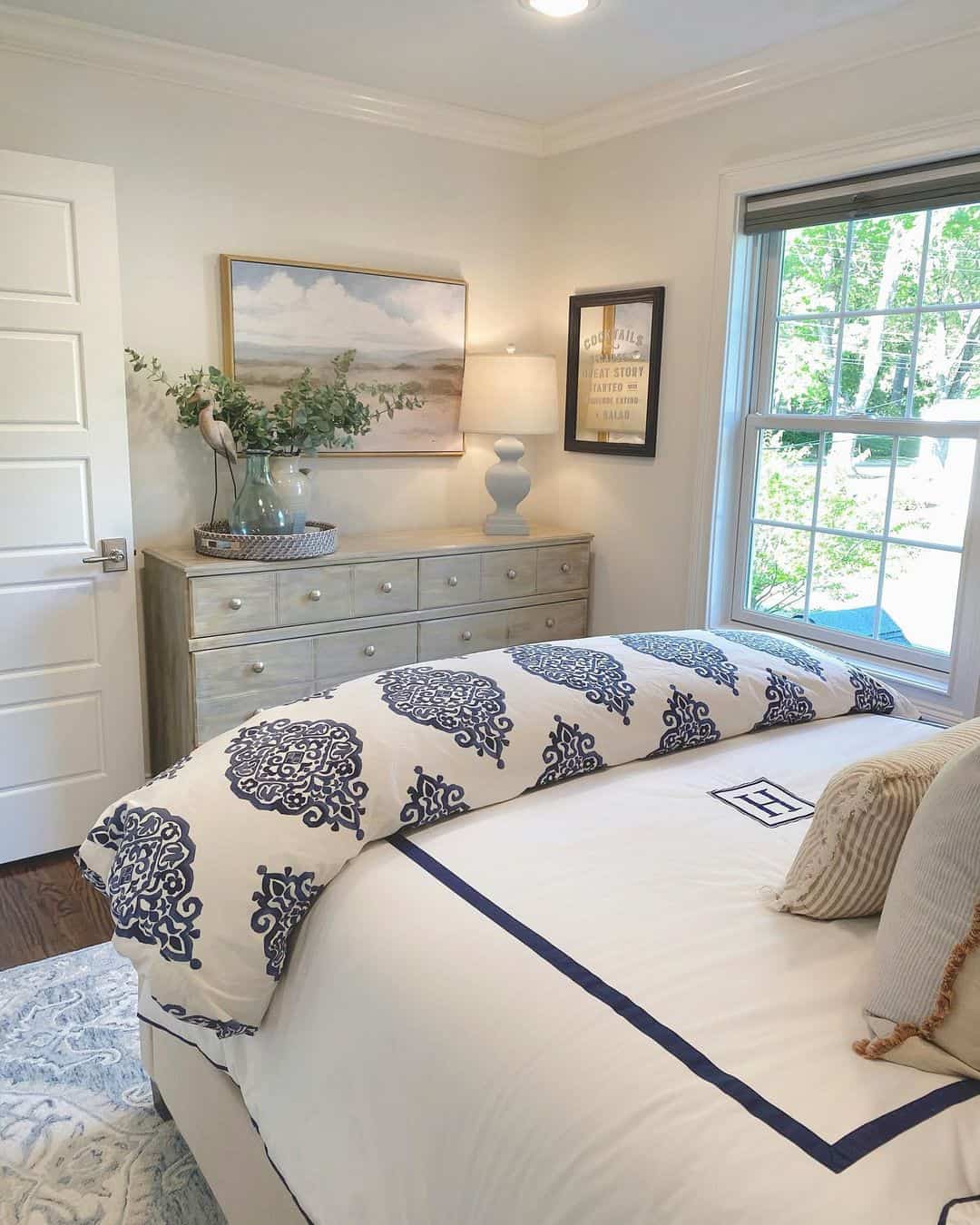 Framed Coastal Landscape Artwork Above a Light Wood Dresser