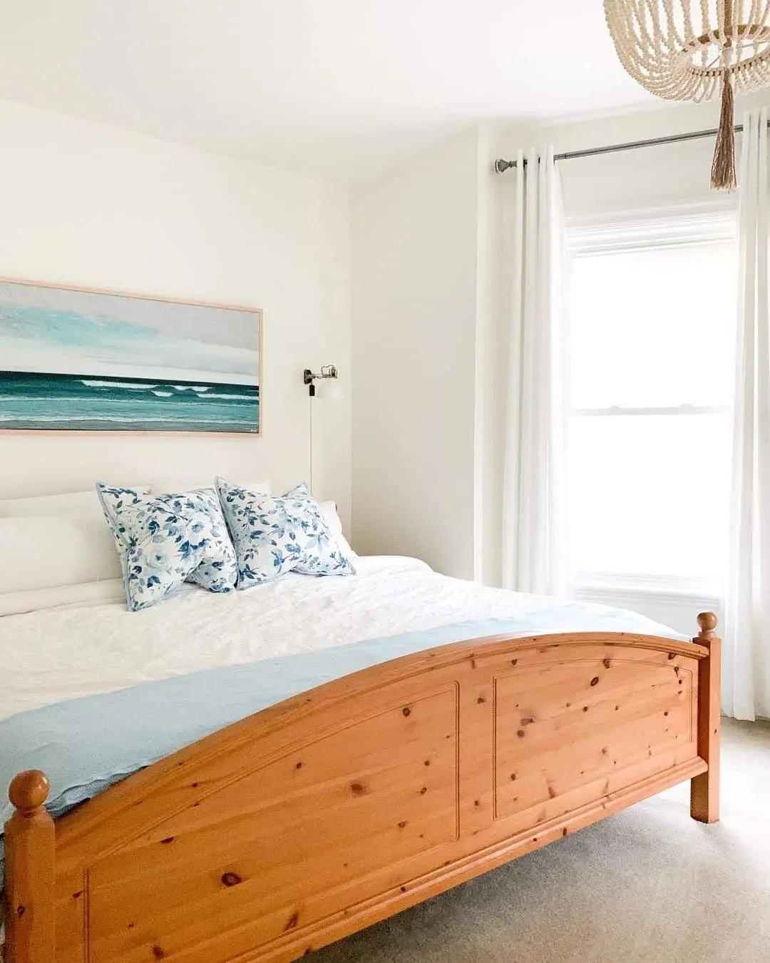 Ocean Wave Artwork Anchors the Bed with Coastal Blue Accents