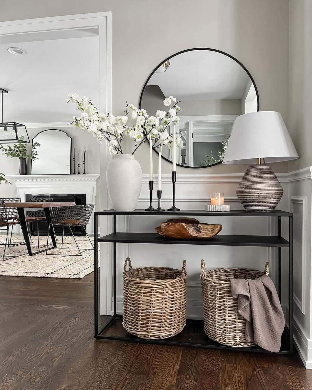 Round Mirror Above Console Table Reflects Light