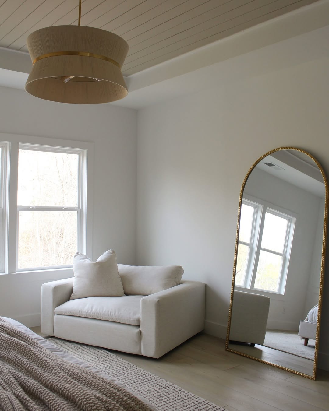 Arched Gold Mirror Expands a Cozy Corner