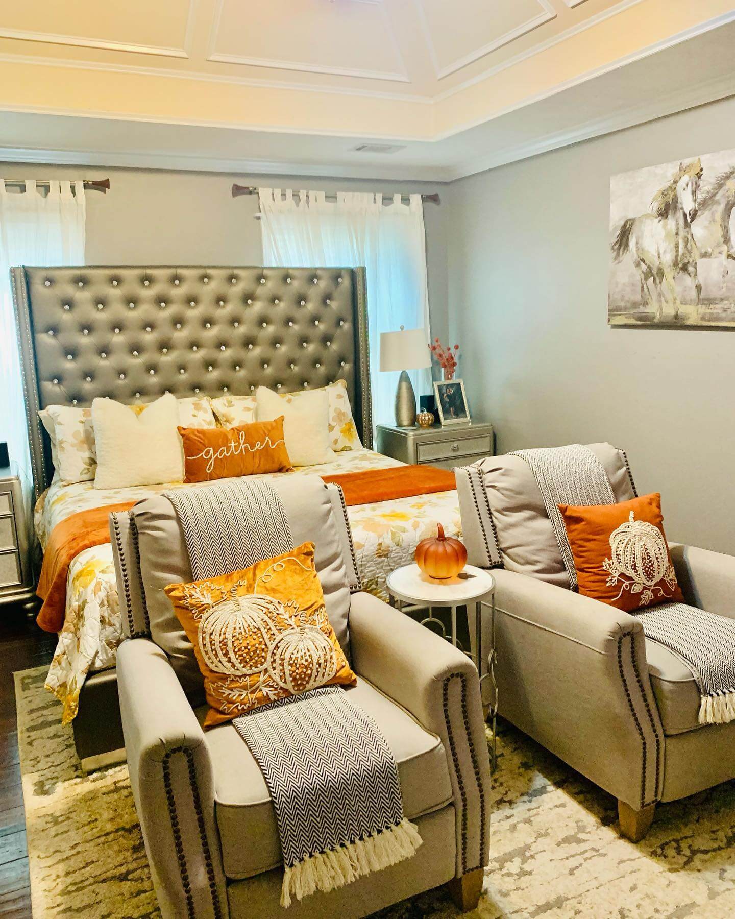 Orange Pumpkin Pillows Layered on Neutral Chairs
