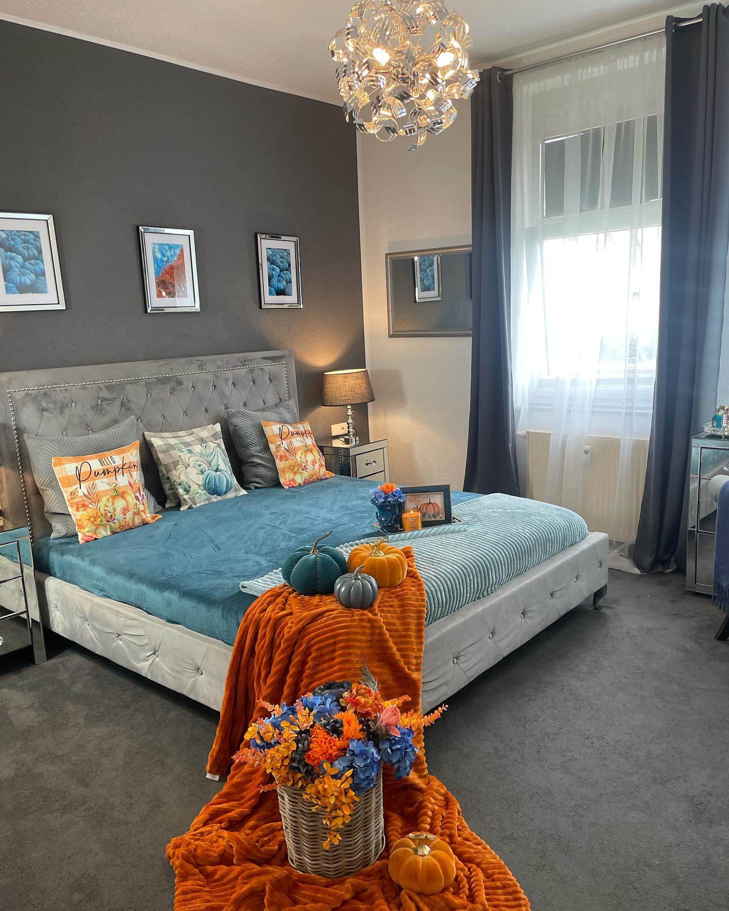 Orange Throw Blanket Drapes Over Bed With Pumpkin Accents