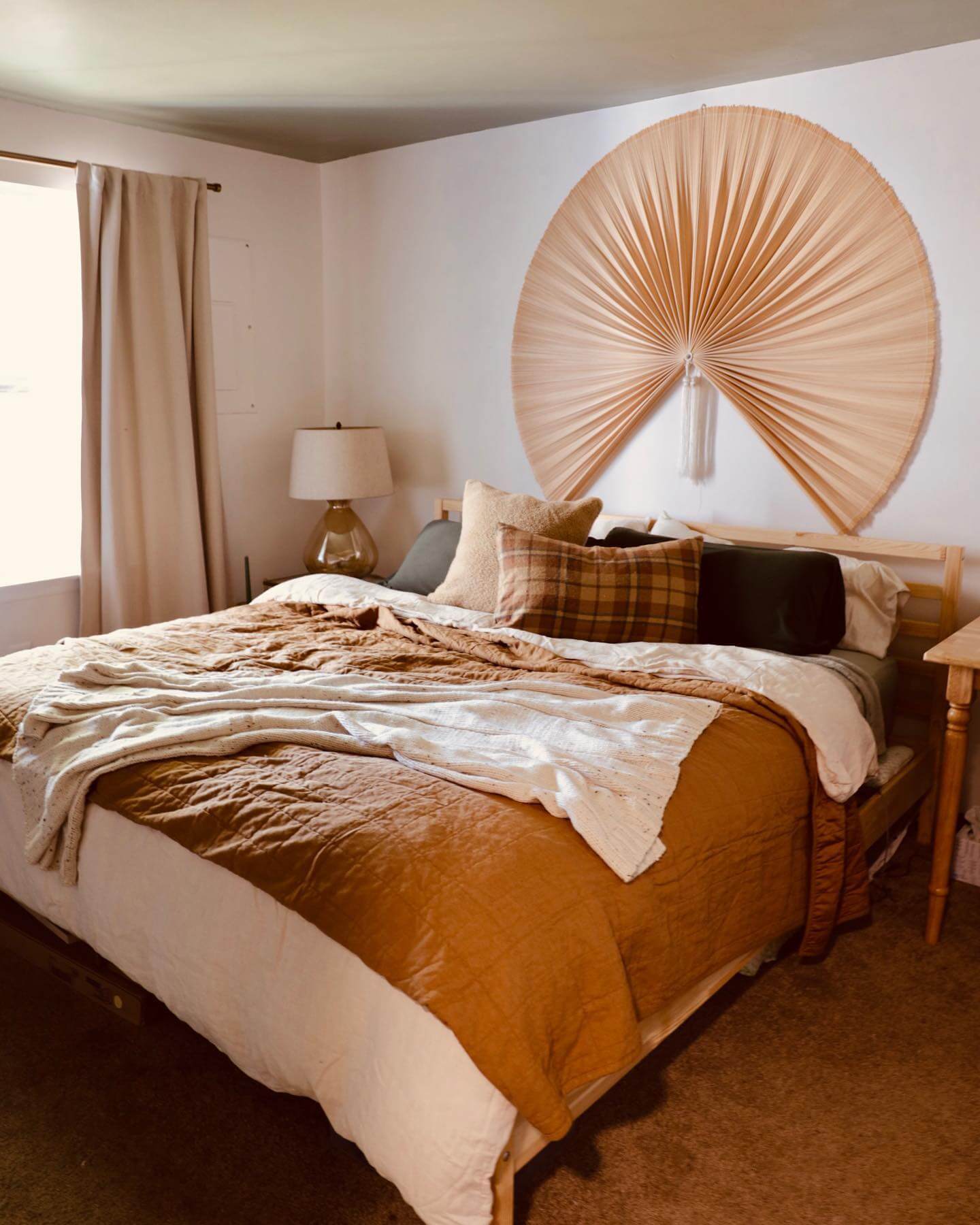 Fan-Shaped Wall Hanging Adds Organic Texture Above the Bed