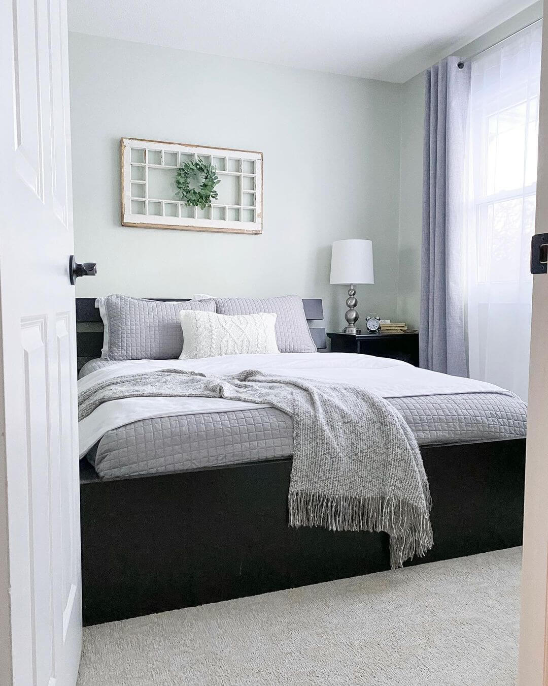 Windowpane Frame With Wreath Adds Rustic Charm Above the Bed