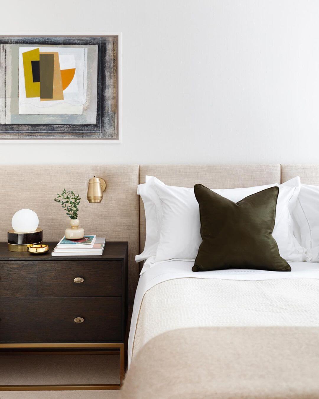 Brass Sconce Adds Warm Task Lighting Above the Nightstand