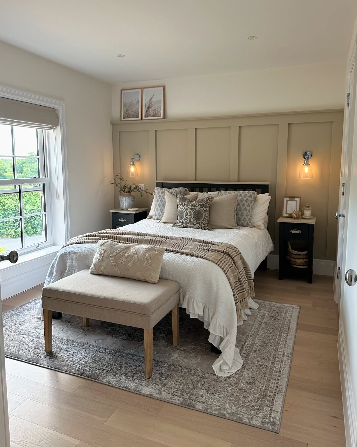 Paneled Wall Creates a Cozy, Neutral Backdrop for the Bed