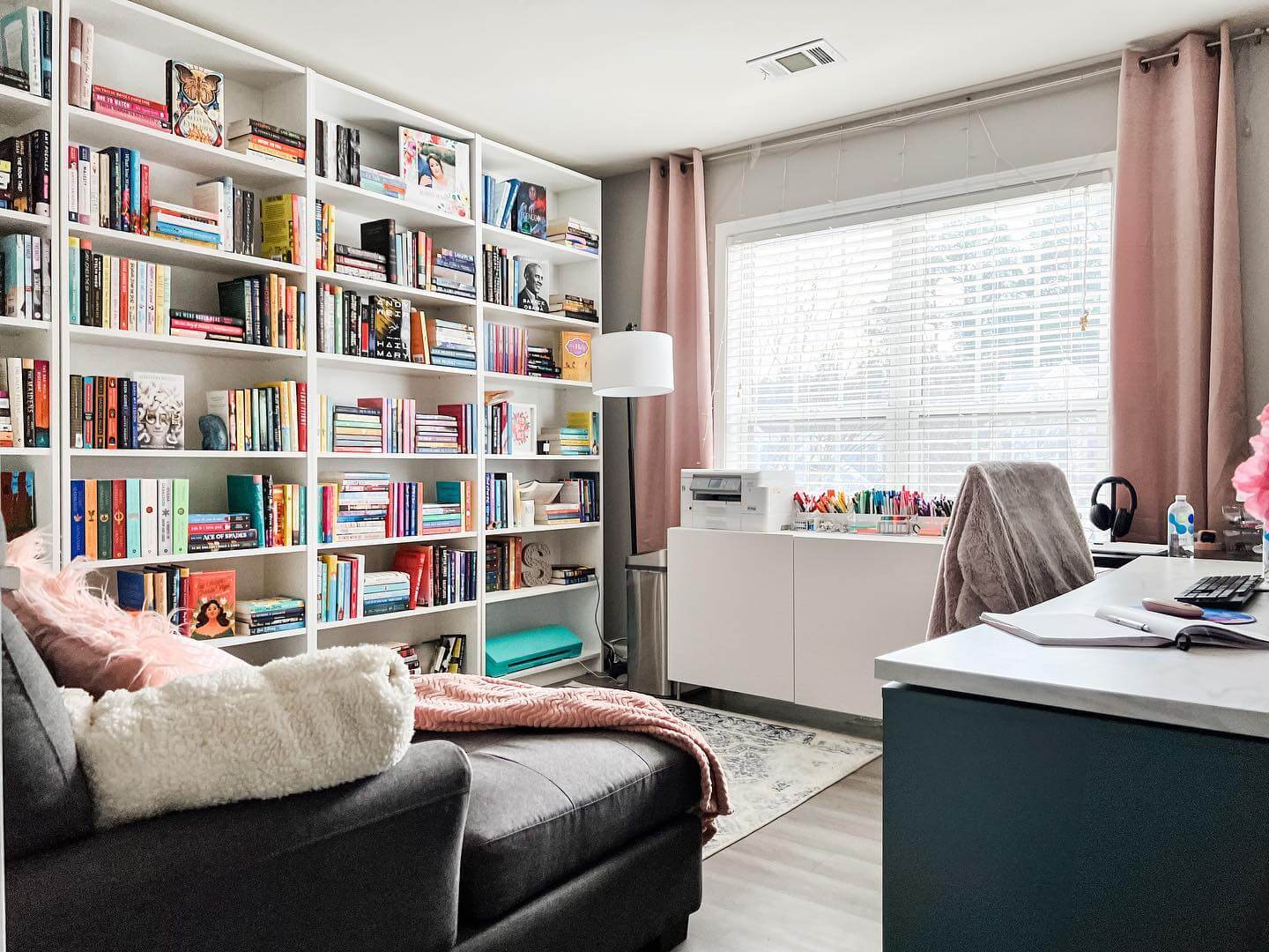 White Built-In Shelving Units Hold a Vast Book Collection