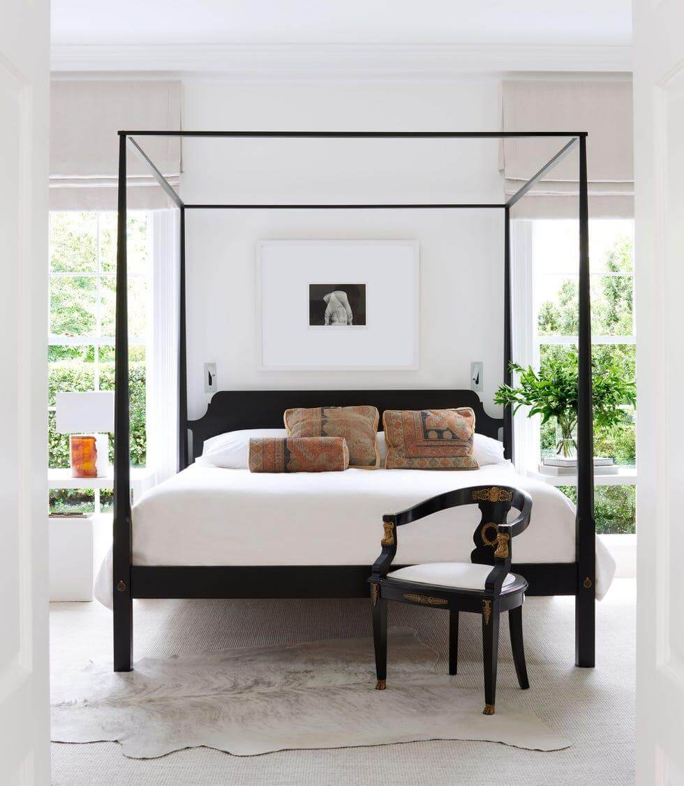 Black Four-Poster Bed Creates a Dramatic Canopy for Cozy Sleep