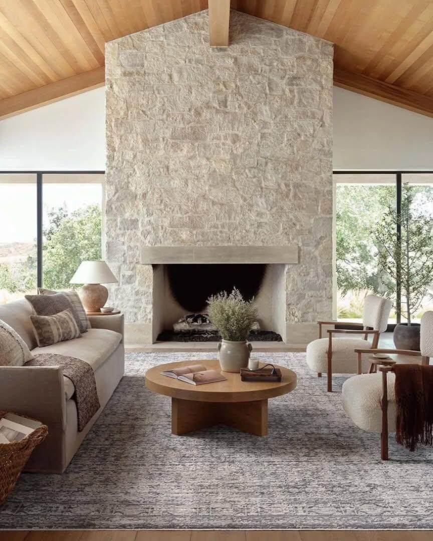 Stone Fireplace Wall Anchors a Vaulted Ceiling Room