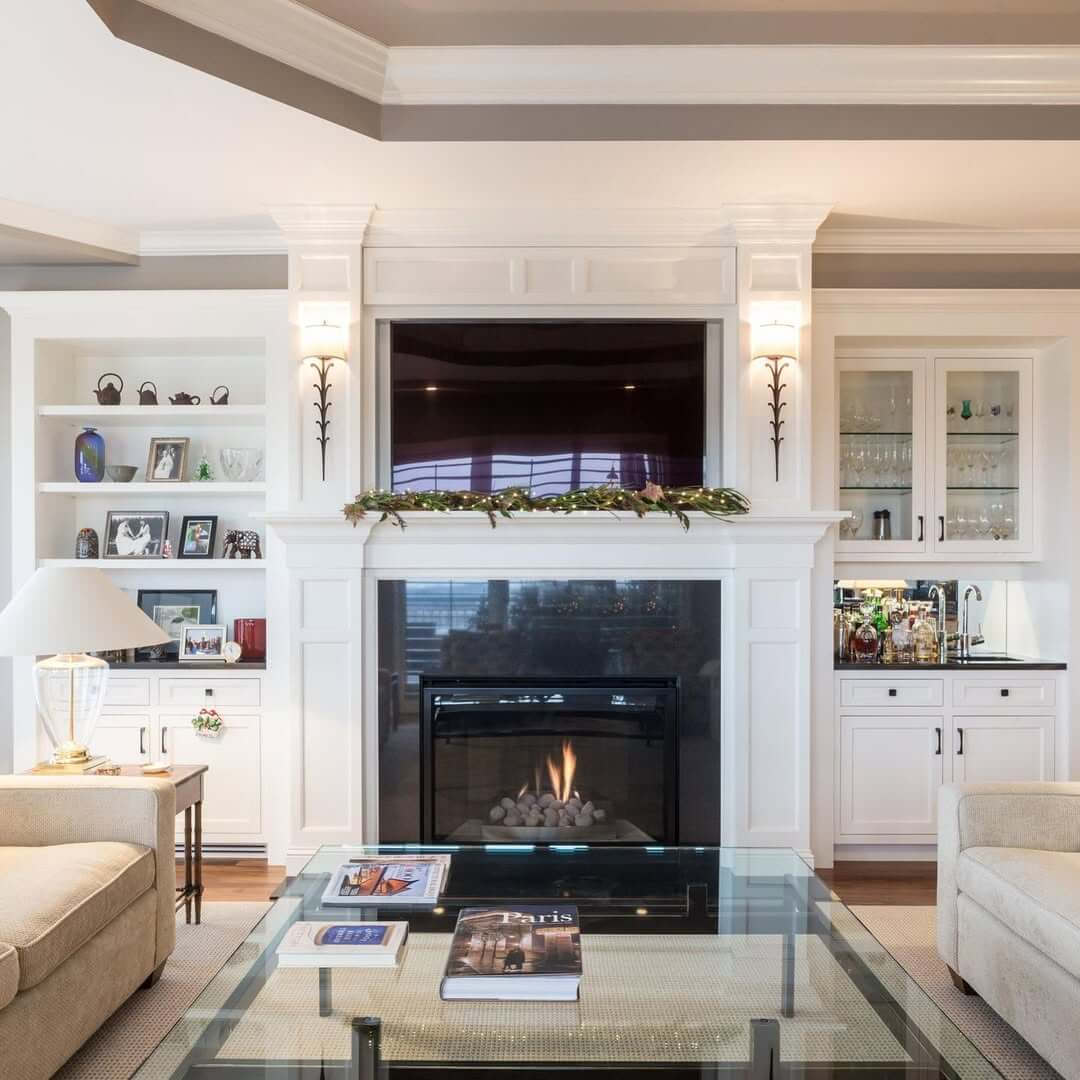 Built-in Bar and Display Cabinets Flank the Fireplace