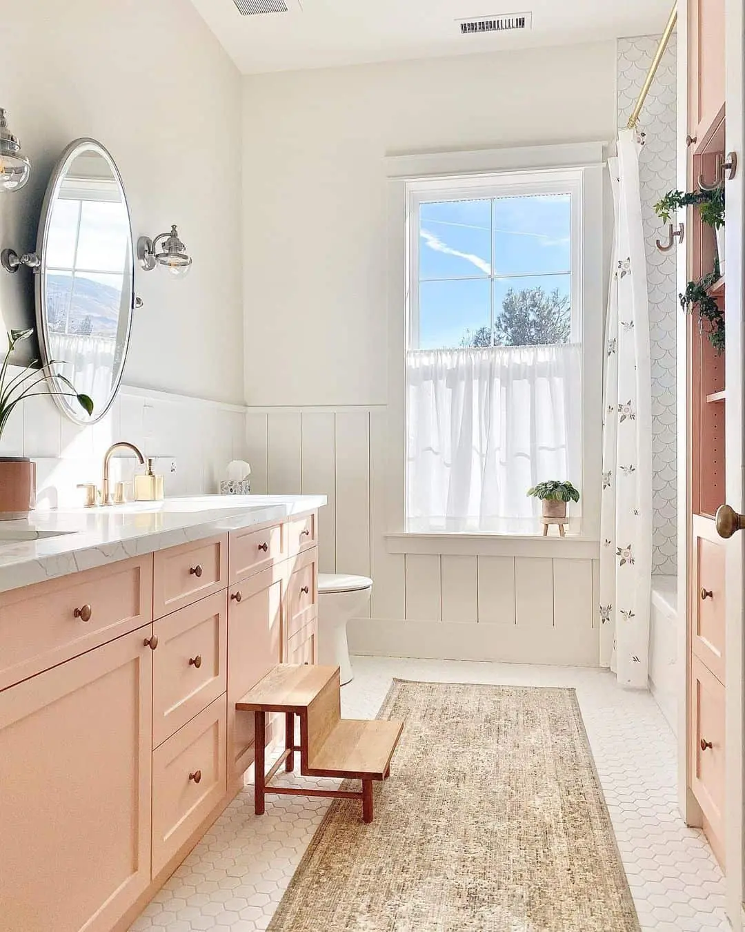 Soft Pink Vanity Cabinets with Brass Hardware