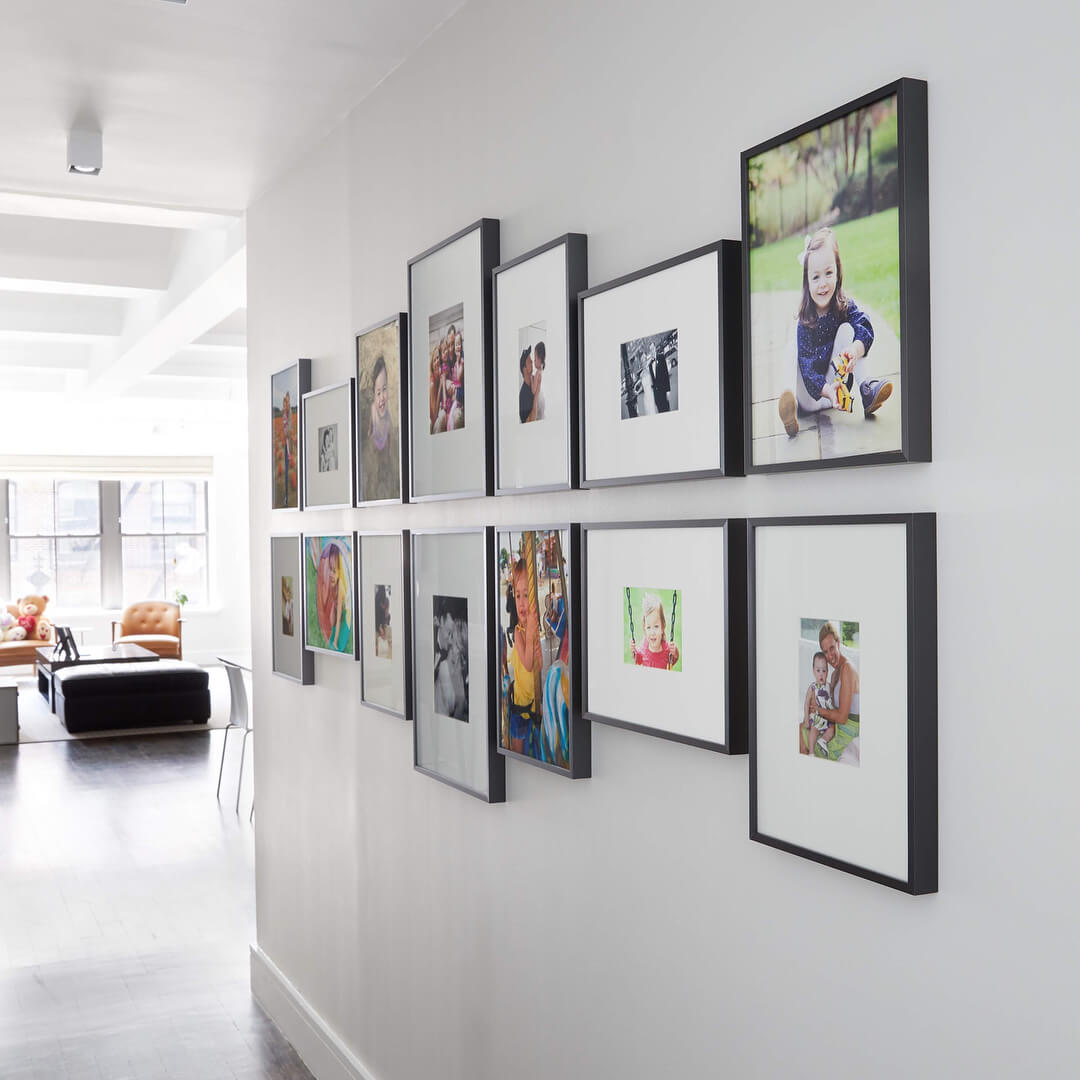 Two Rows of Black Frames Create a Balanced Gallery Wall