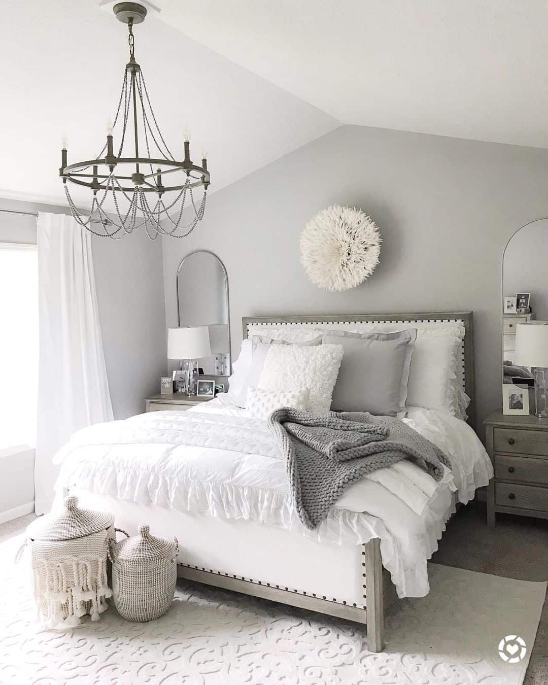 Round Feather Wall Art Adds Organic Texture Above the Bed