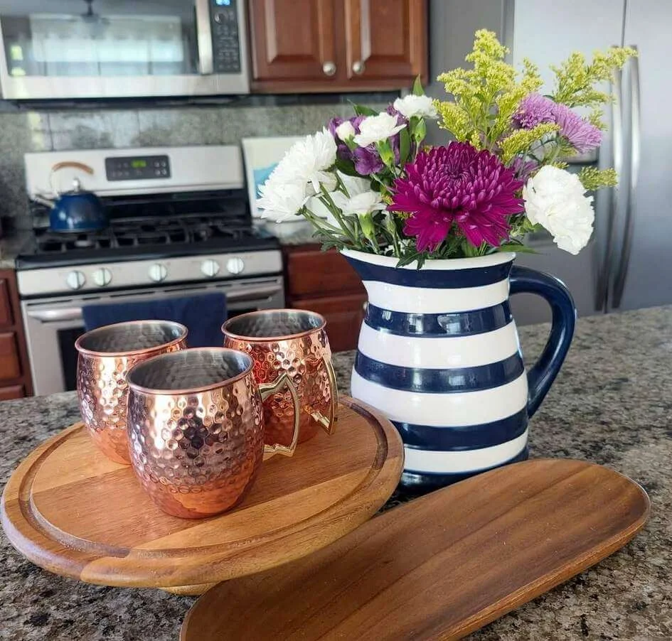 Striped Pitcher Holds a Colorful Bouquet of Fresh Blooms