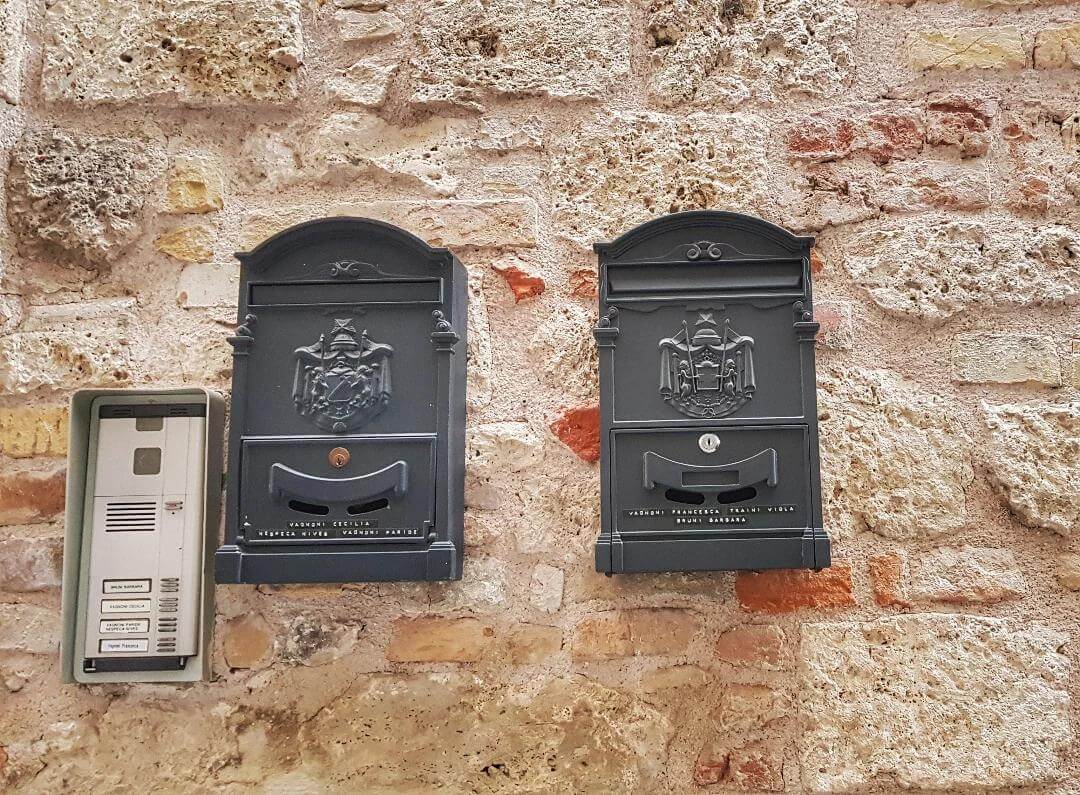 Symmetrical Ornate Black Mailboxes with Traditional Crests