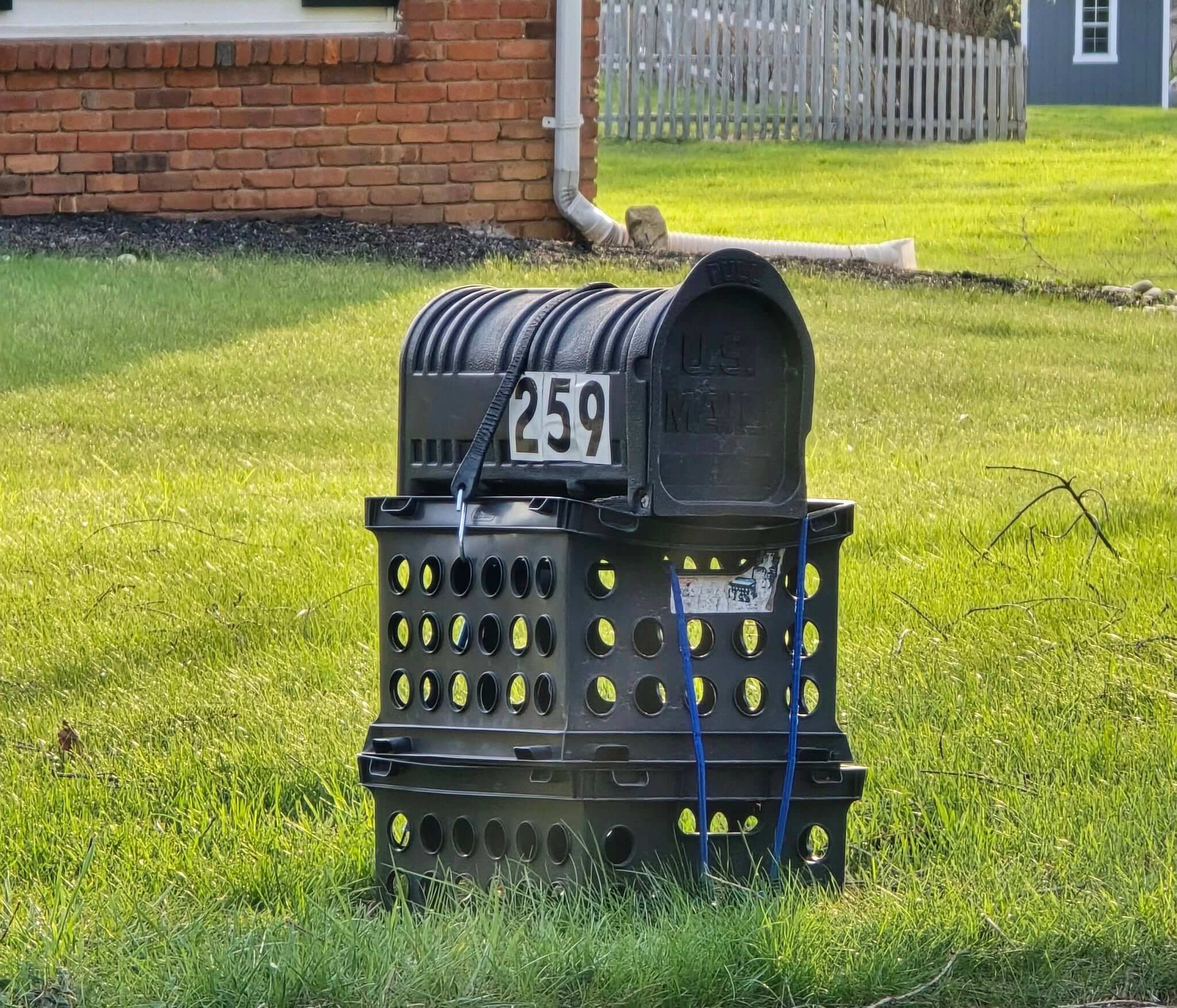 Stacked Black Crates for a Unique Mailbox Base