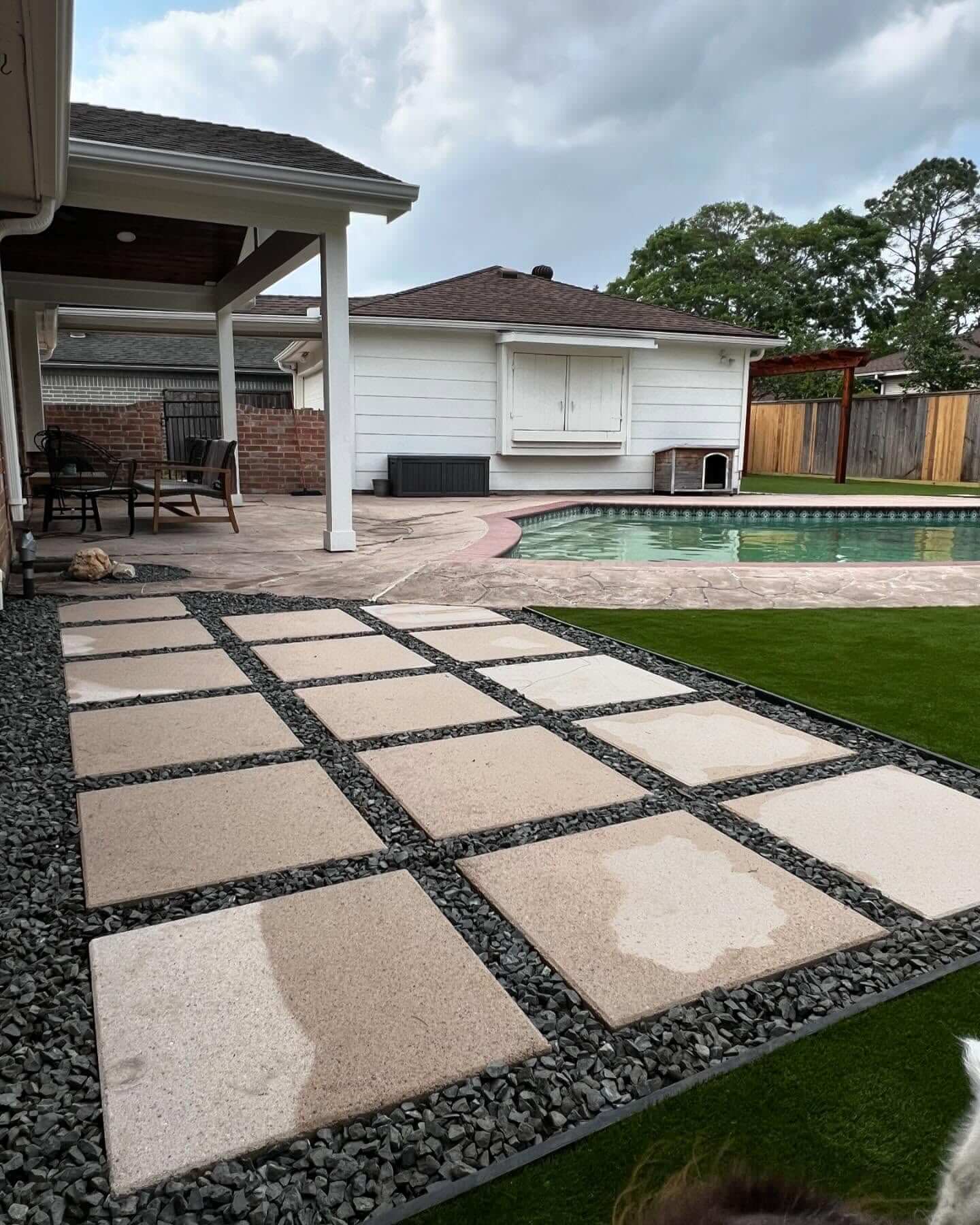 Square Beige Pavers Set In Dark Gravel