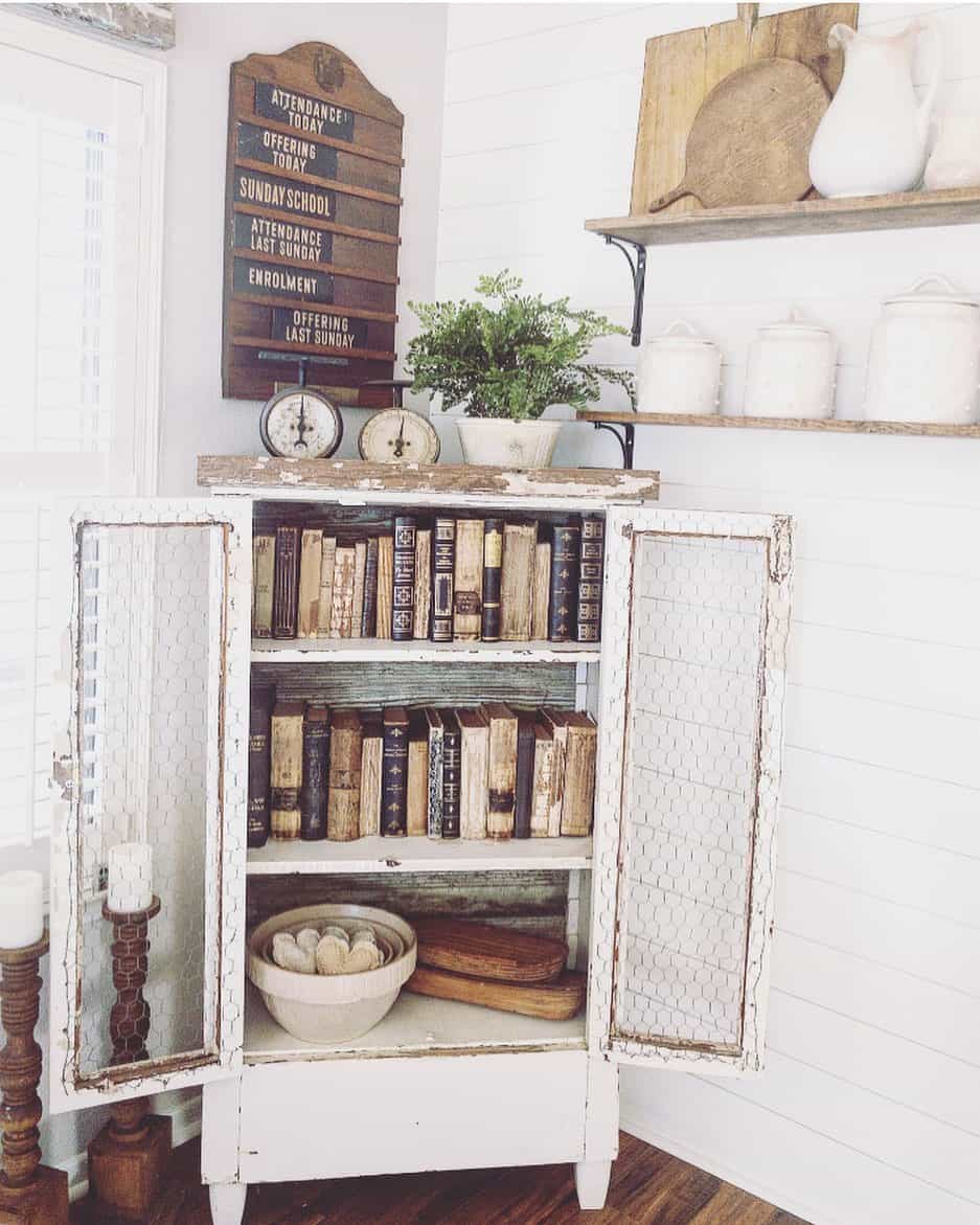 Distressed Cabinet With Chicken Wire Doors Offers Vintage Book Storage