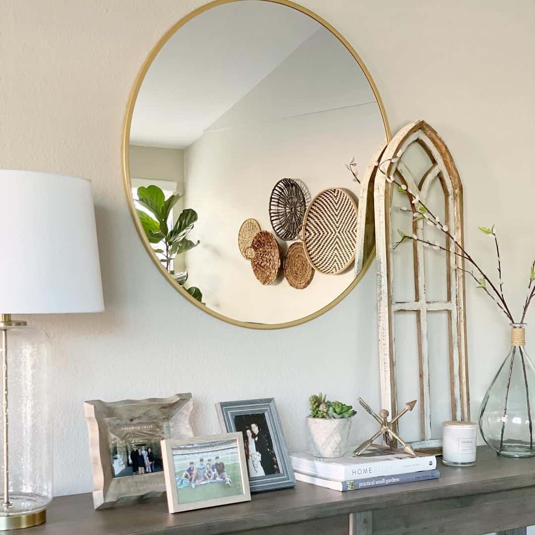 Round Mirror Reflects Textured Wall Baskets