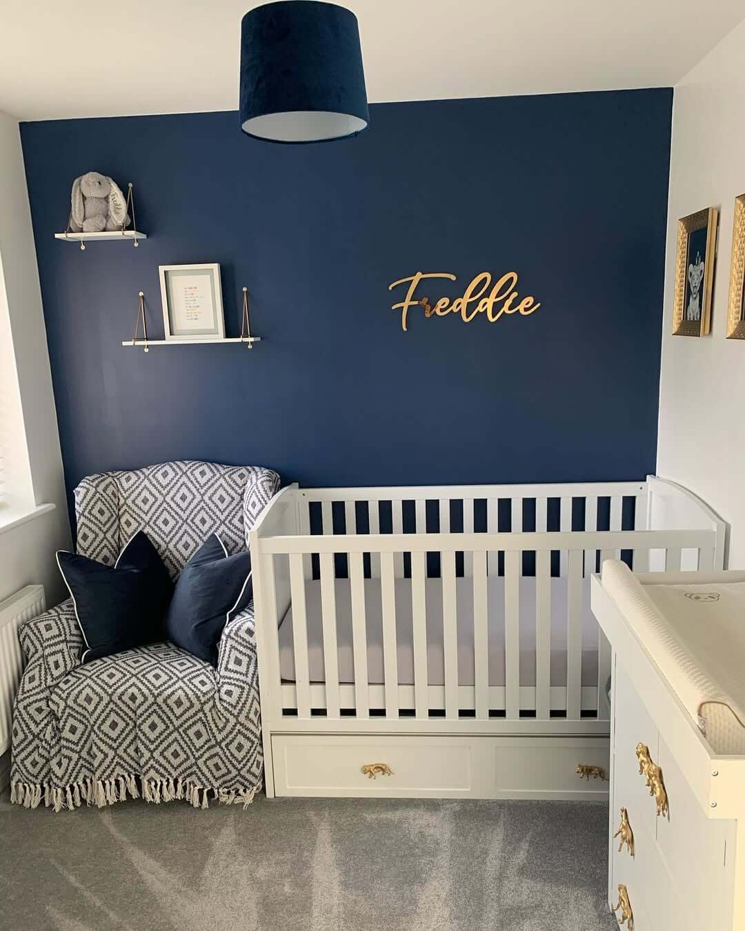 Deep Navy Accent Wall Creates a Cozy Nursery Backdrop