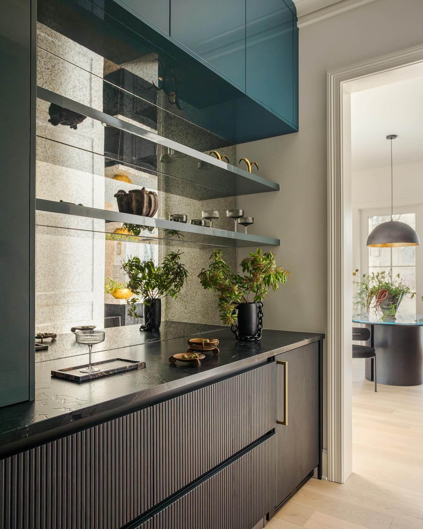 Antiqued Mirror Backsplash Adds Depth and Glamour to Open Shelving