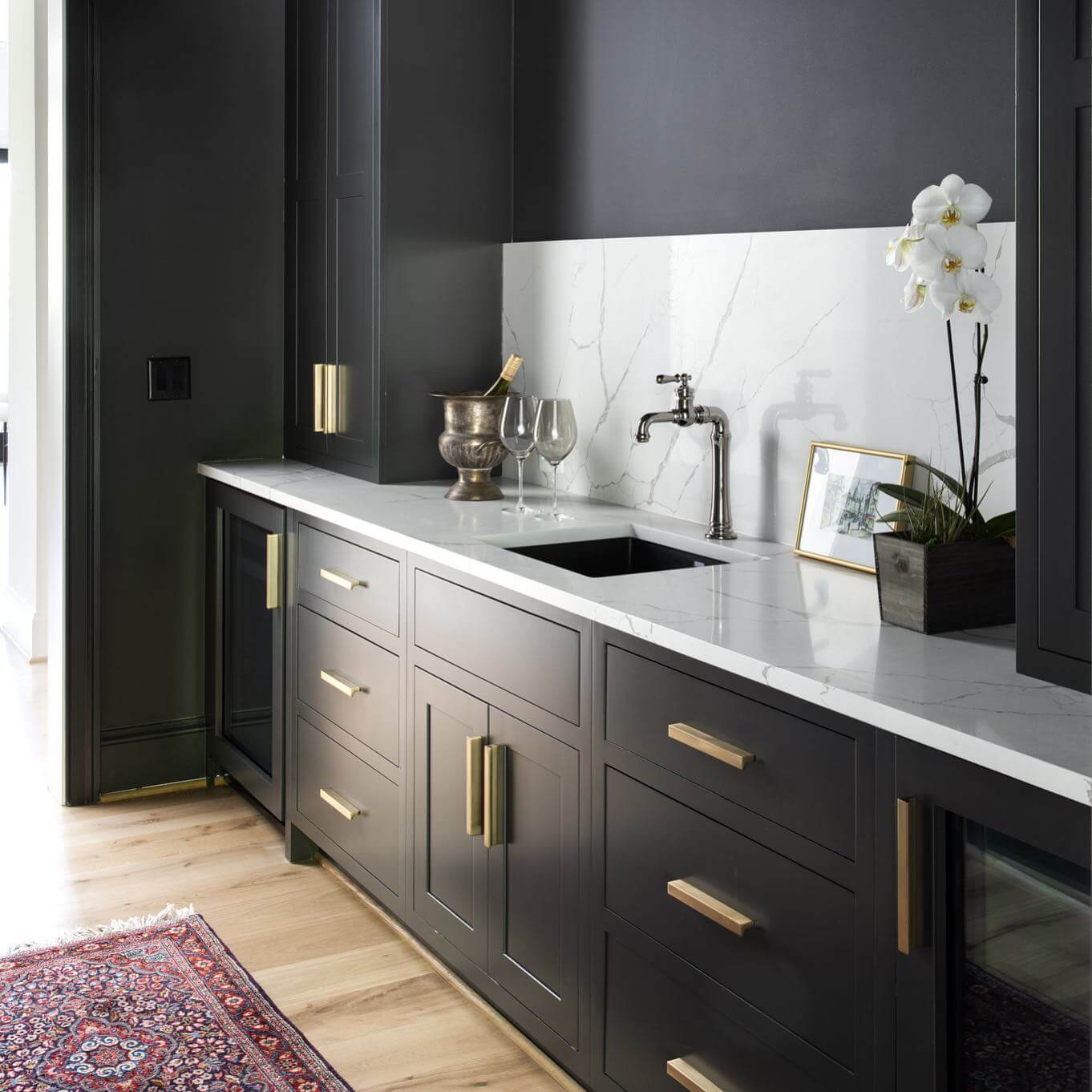 Dark Cabinetry With Brass Hardware Creates a Chic Bar