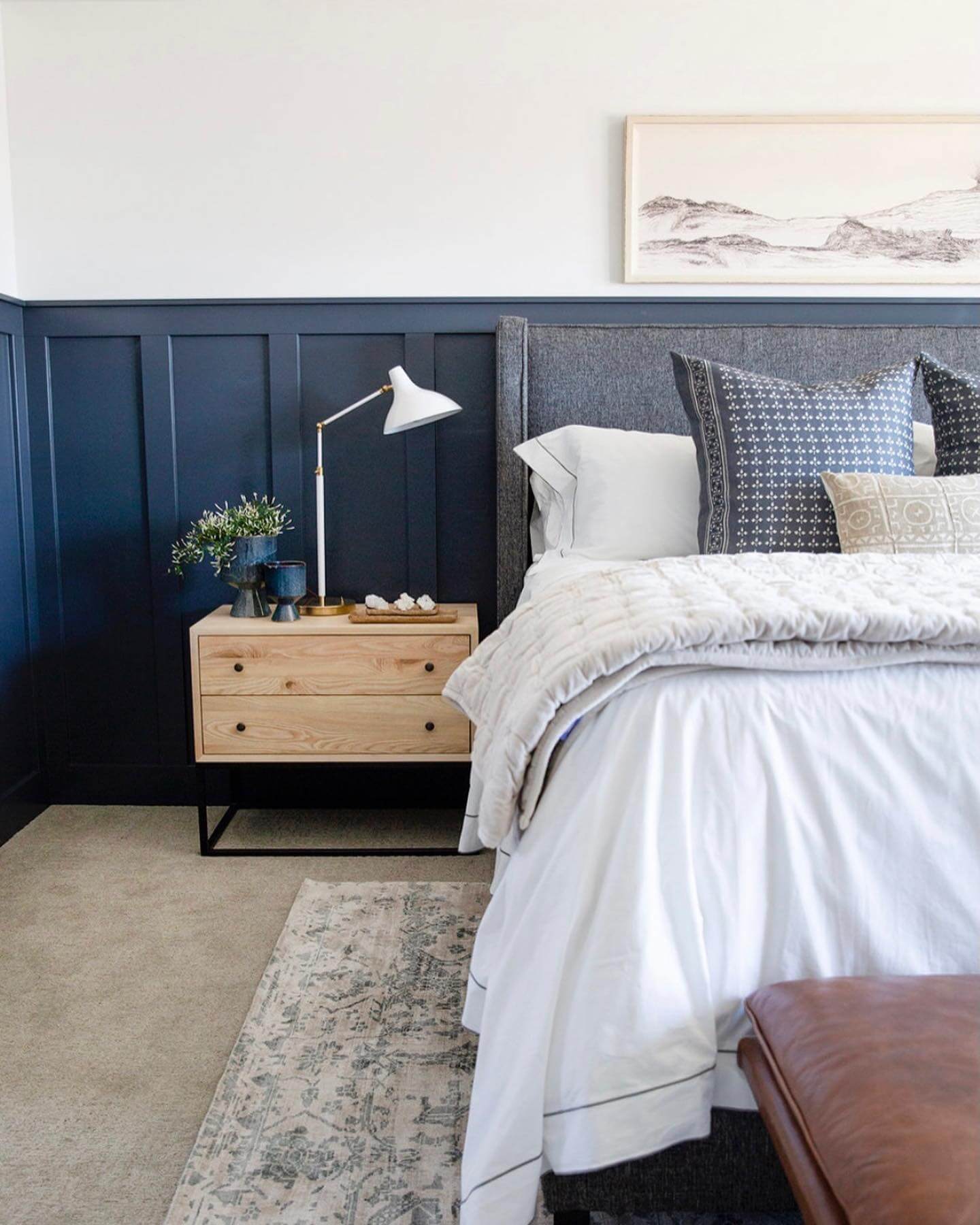 Light Wood Nightstand Adds Warmth to Navy Walls