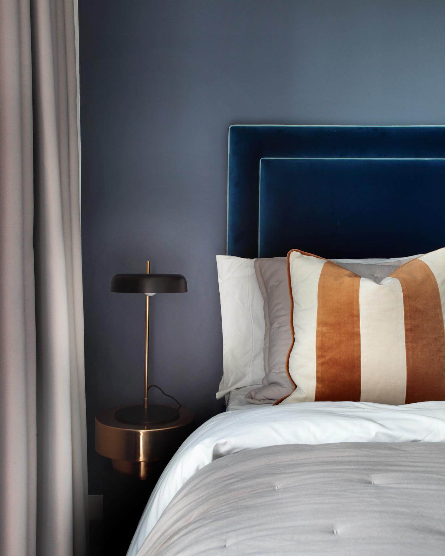 Layered Pillows Add Warmth and Pattern to Navy Bedding