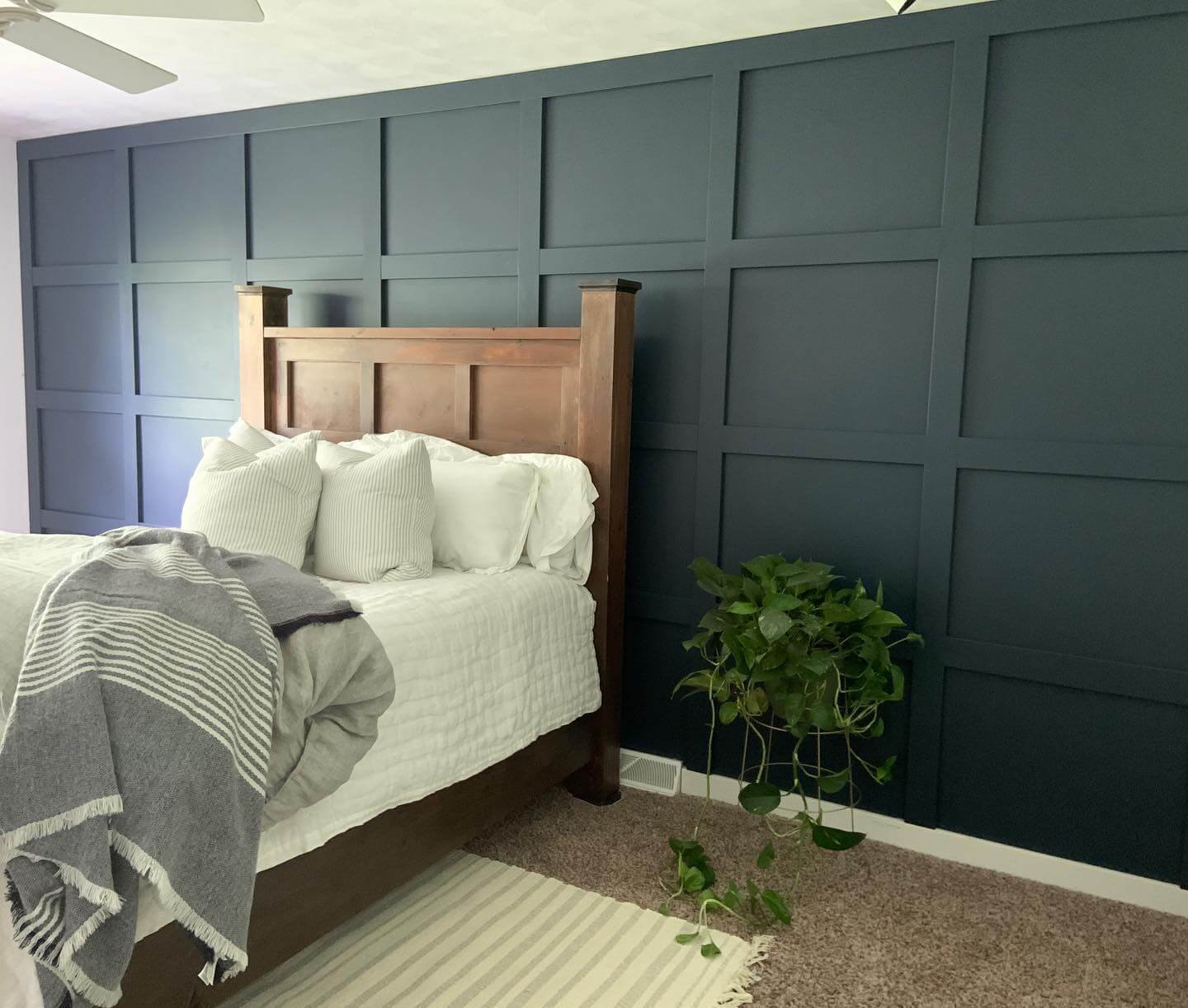 Grid-Paneled Navy Wall Creates a Dramatic Backdrop