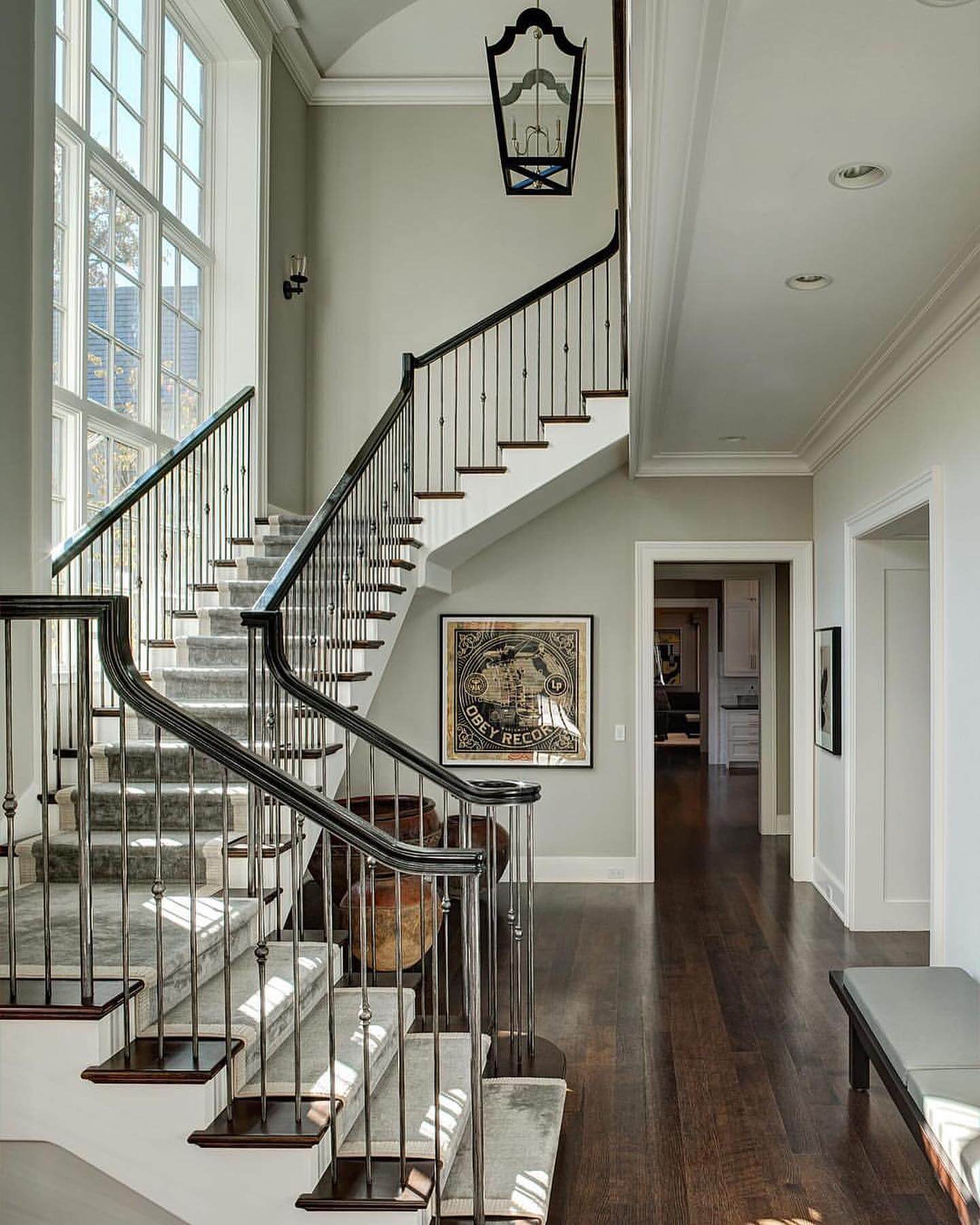 Large Black Lantern Light Hangs Above Staircase