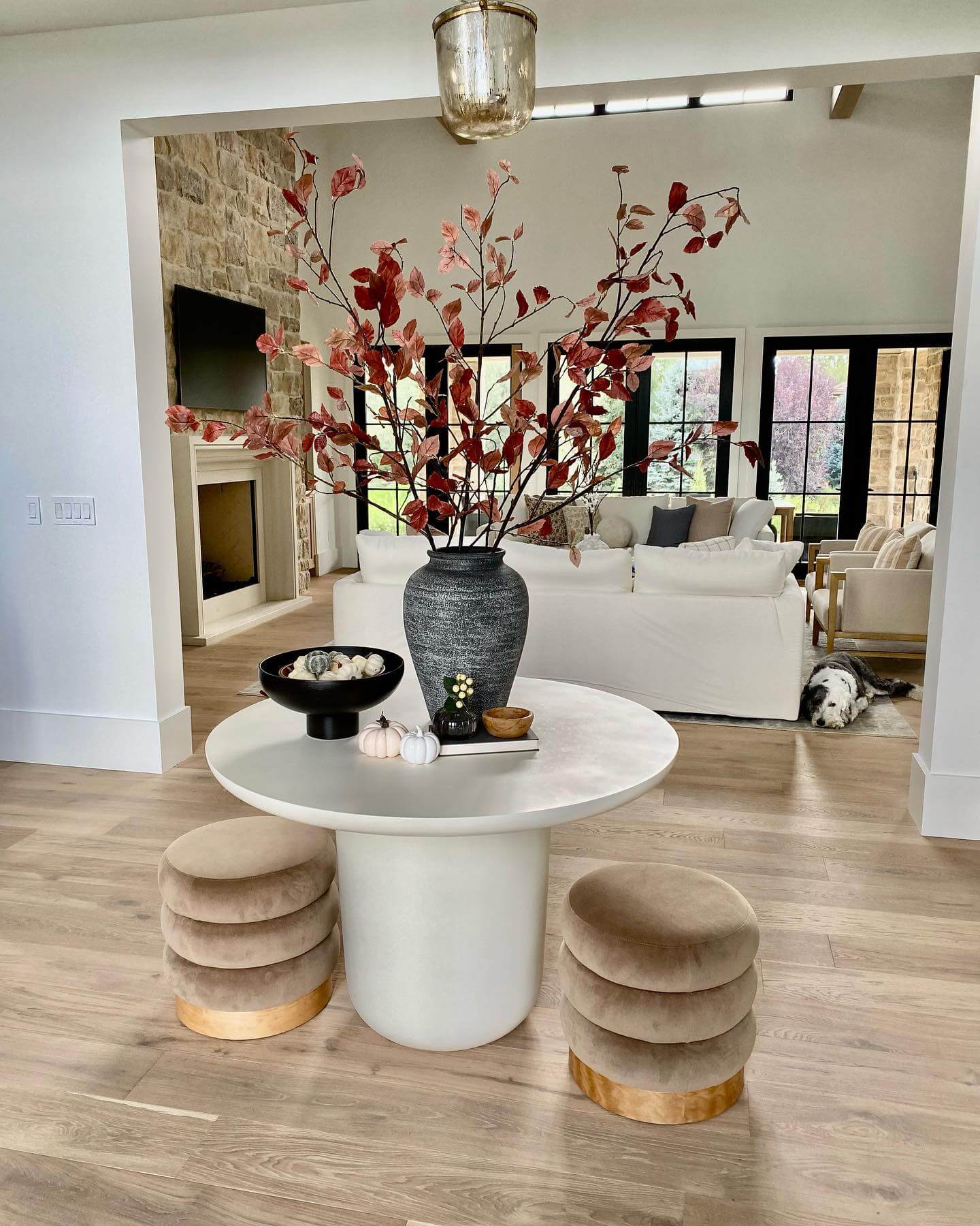 White Pedestal Table with Stacked Velvet Ottomans