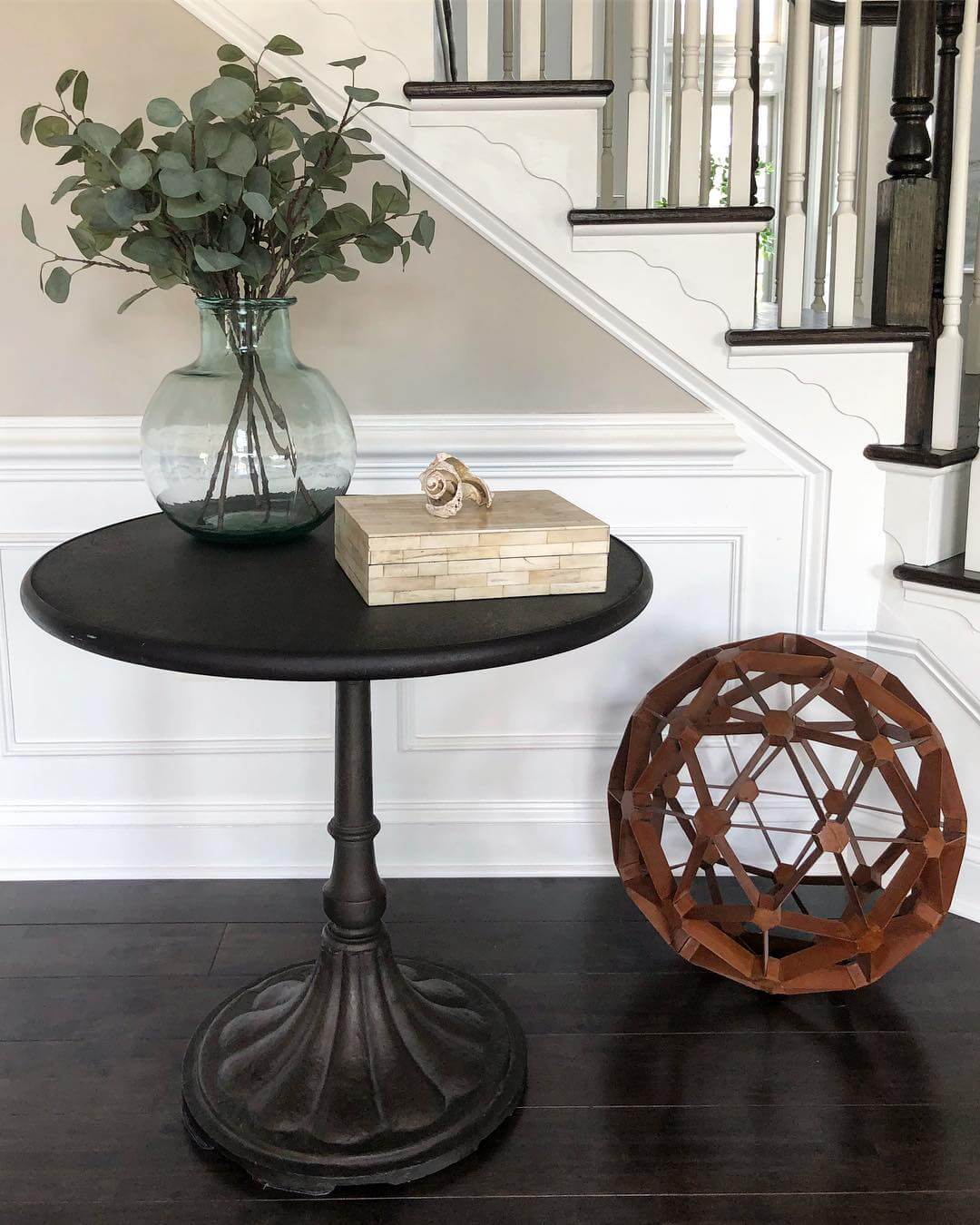 Dark Pedestal Table with Natural Accents