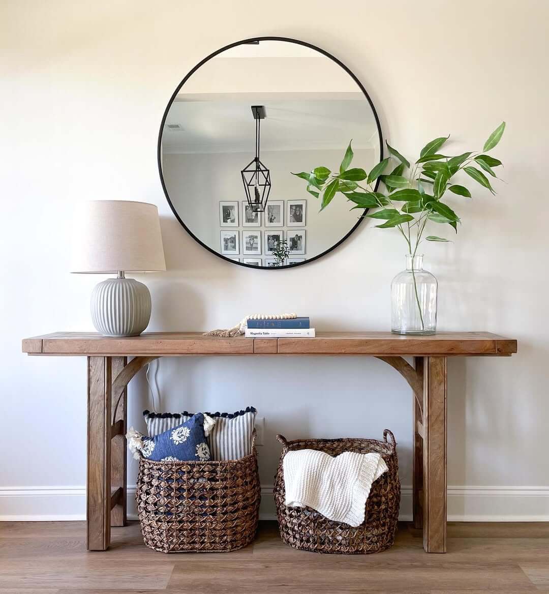 Round Mirror Reflects Gallery Wall and Geometric Pendant