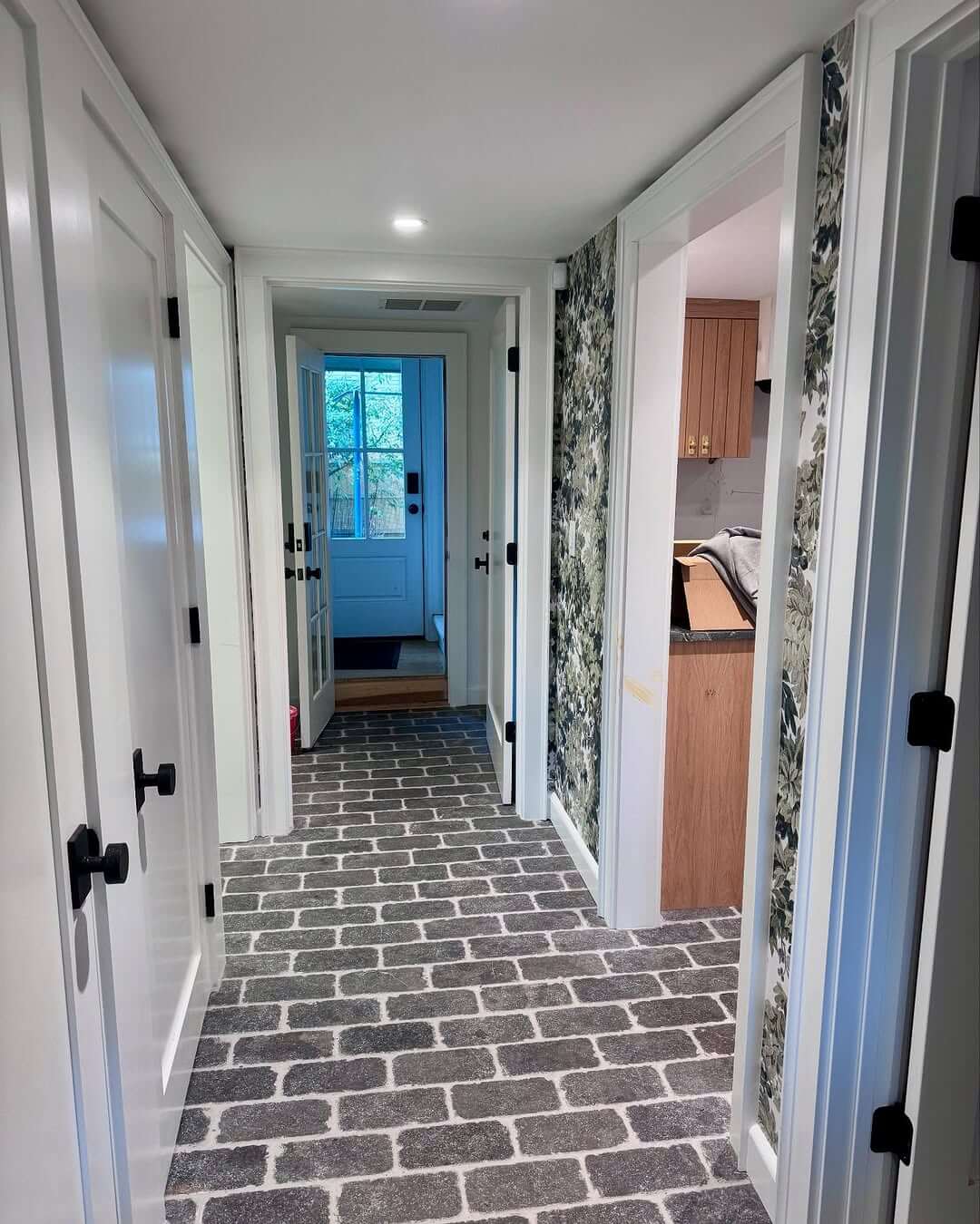 Dark Floral Wallpaper Adds Moody Depth to a Hallway