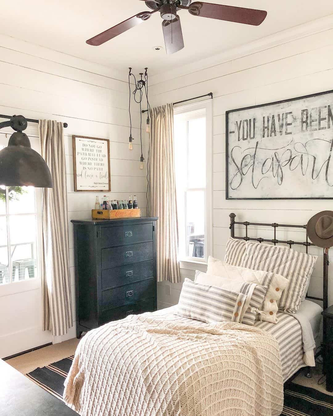 Large Farmhouse Sign Adds a Bold Statement Above the Bed