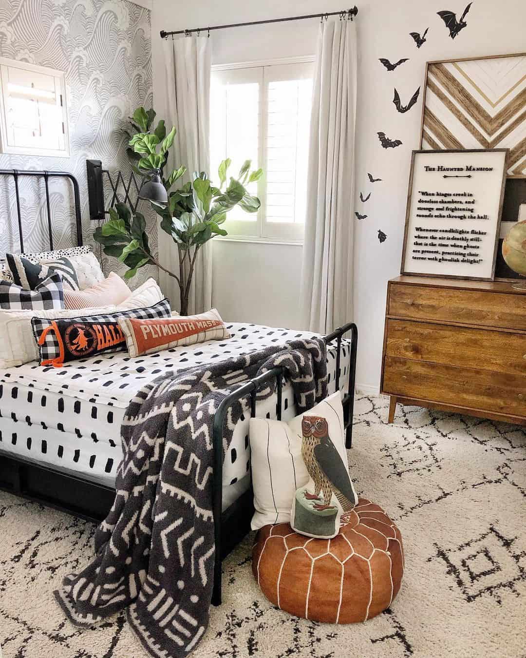 Black Metal Bed Frame Grounds Patterned Bedding and Rug