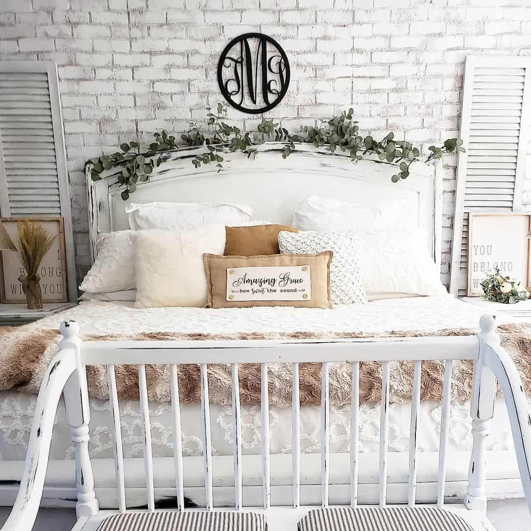 Garlands of Greenery Drape Over White Farmhouse Headboards