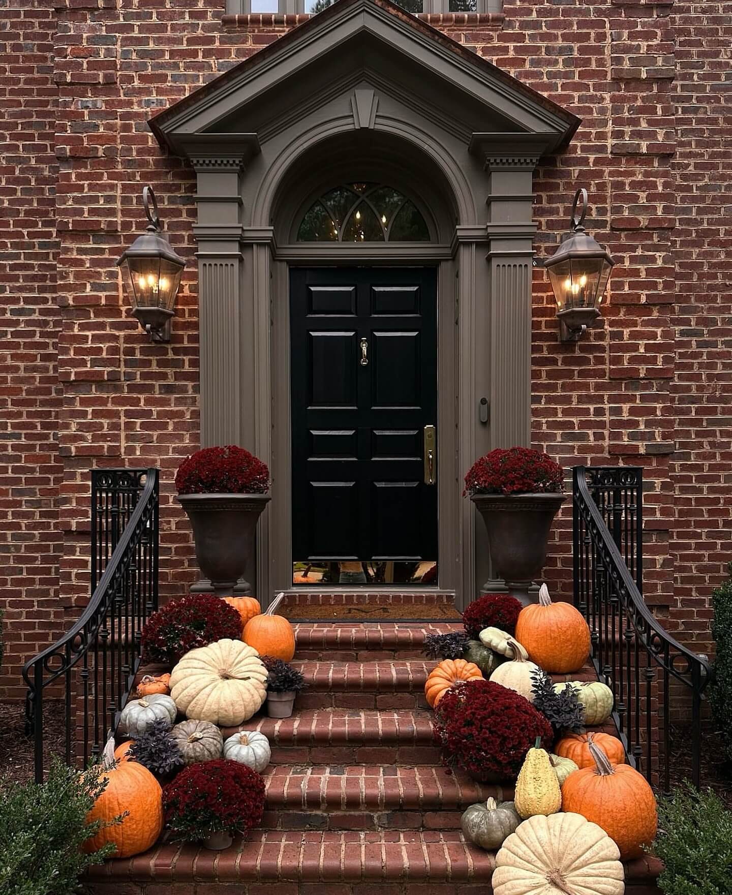 Assorted Pumpkins and Deep Red Mums Create a Staircase Display