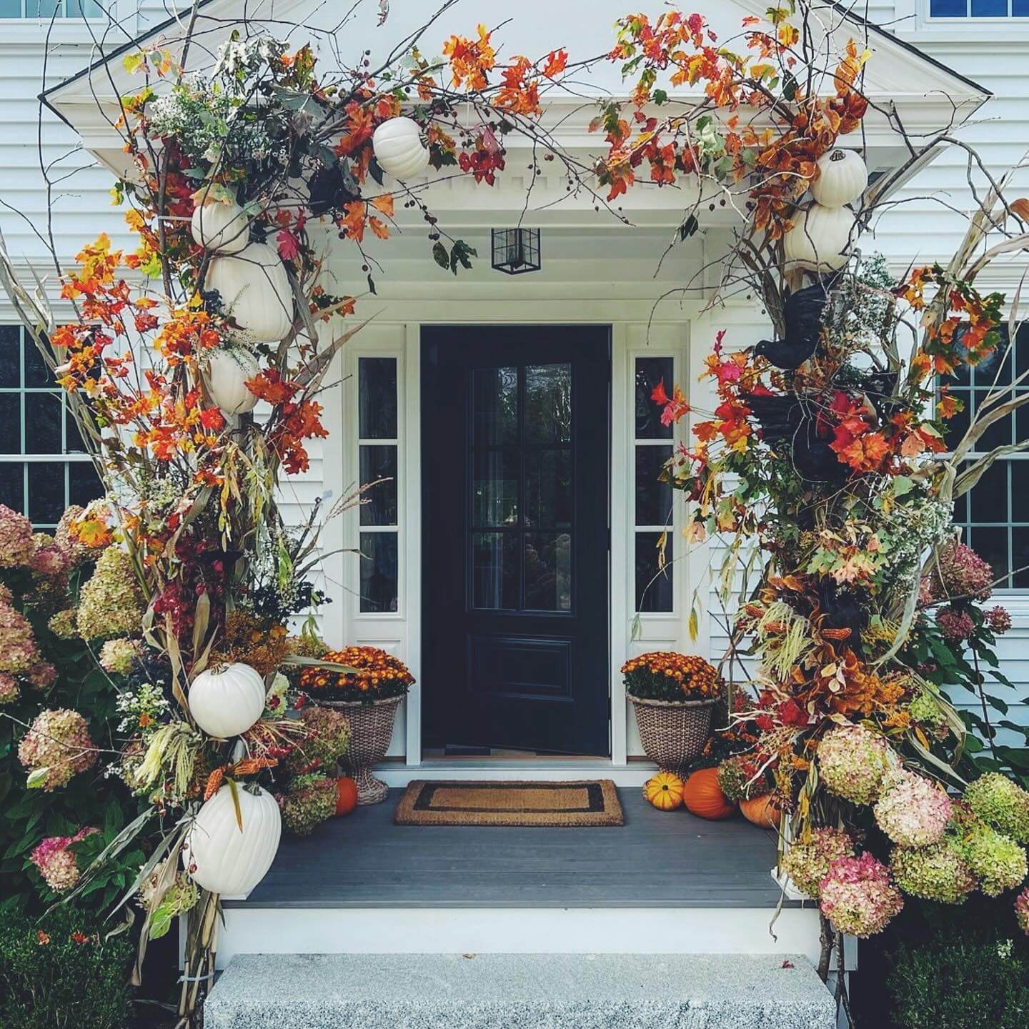 White Pumpkins and Dried Hydrangeas Create a Textured Fall Arch