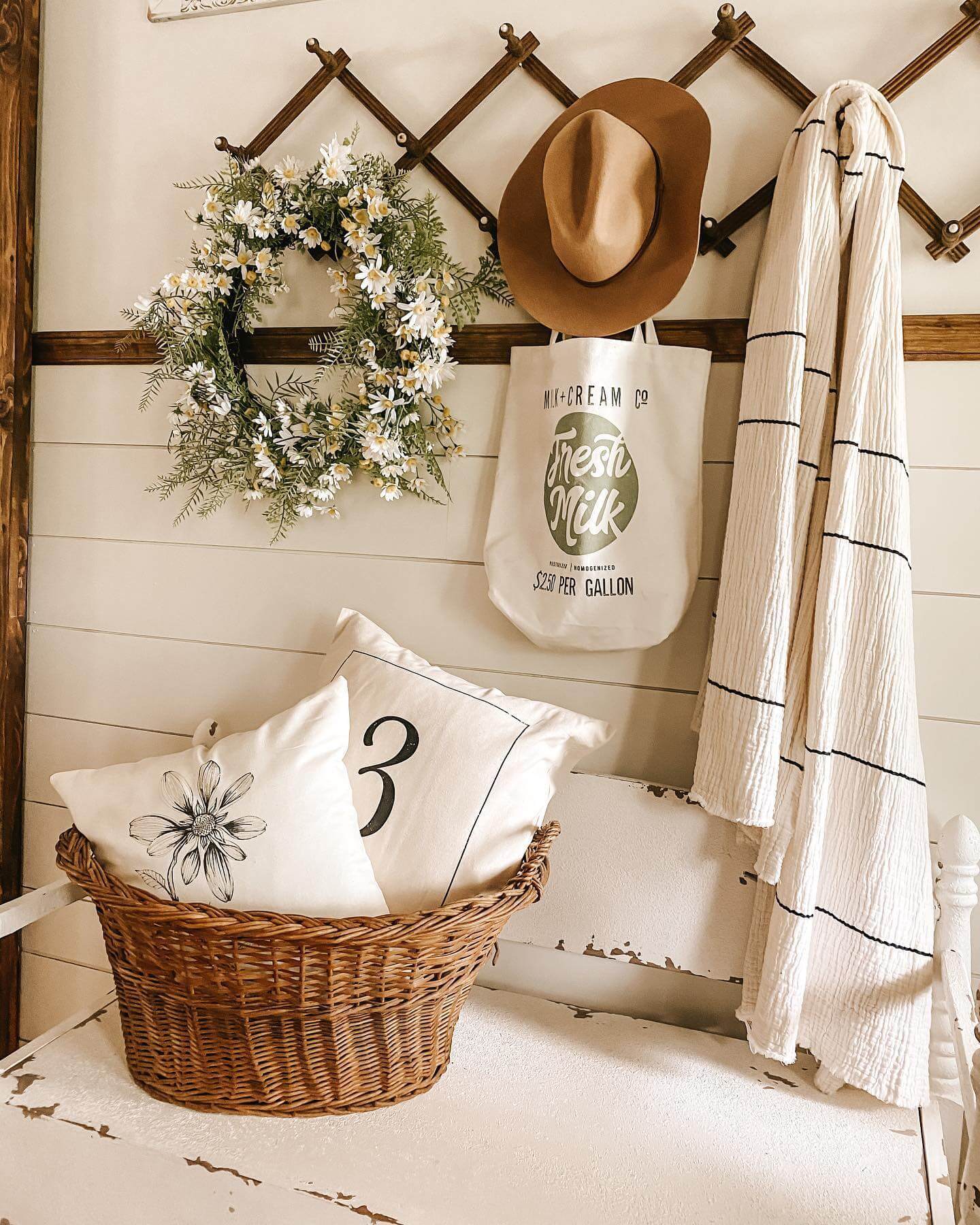 Woven Basket Holds Graphic Pillows for a Cozy Entryway
