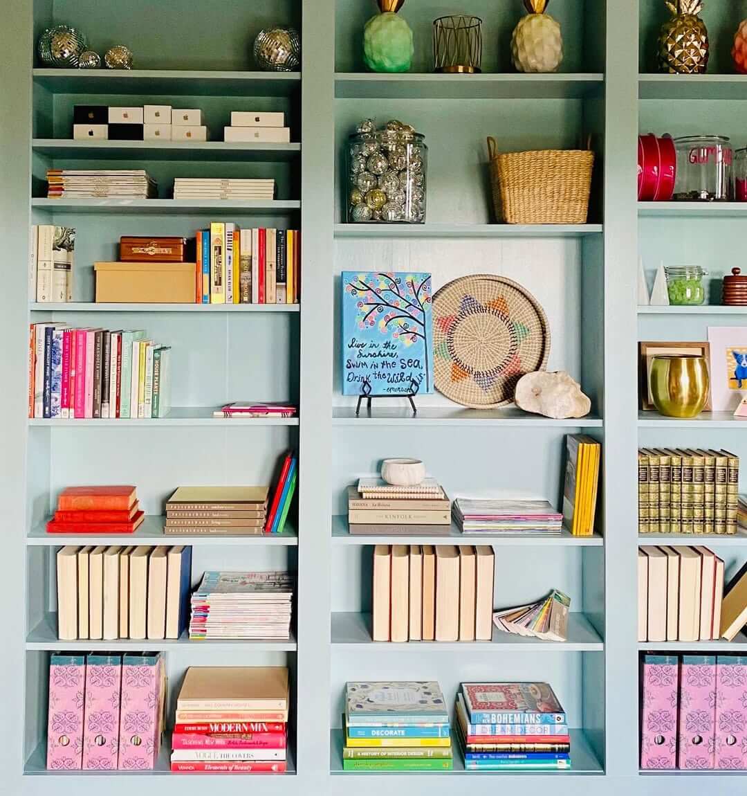 Grouped light-spine books create a subtle visual rhythm