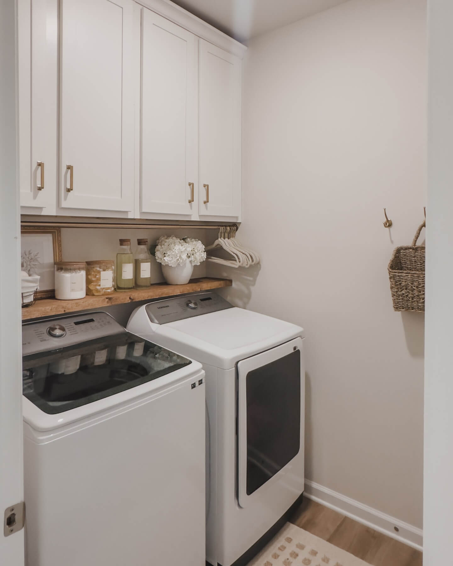 Wooden shelf displays decor and supplies above machines