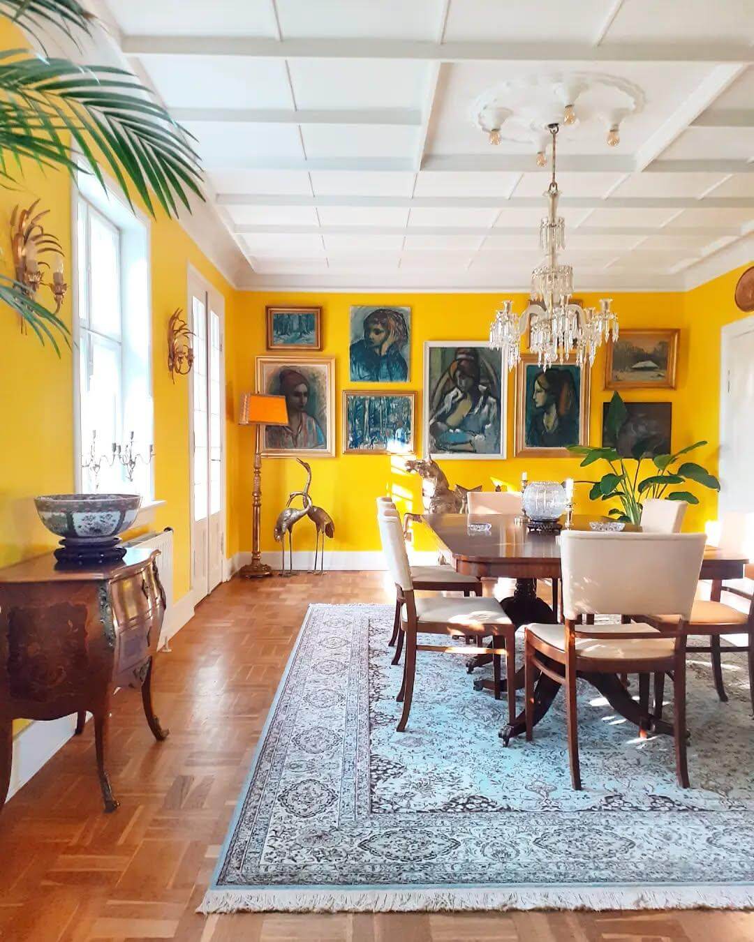 Gallery of Portraits and Landscapes Adds Richness to Yellow Walls