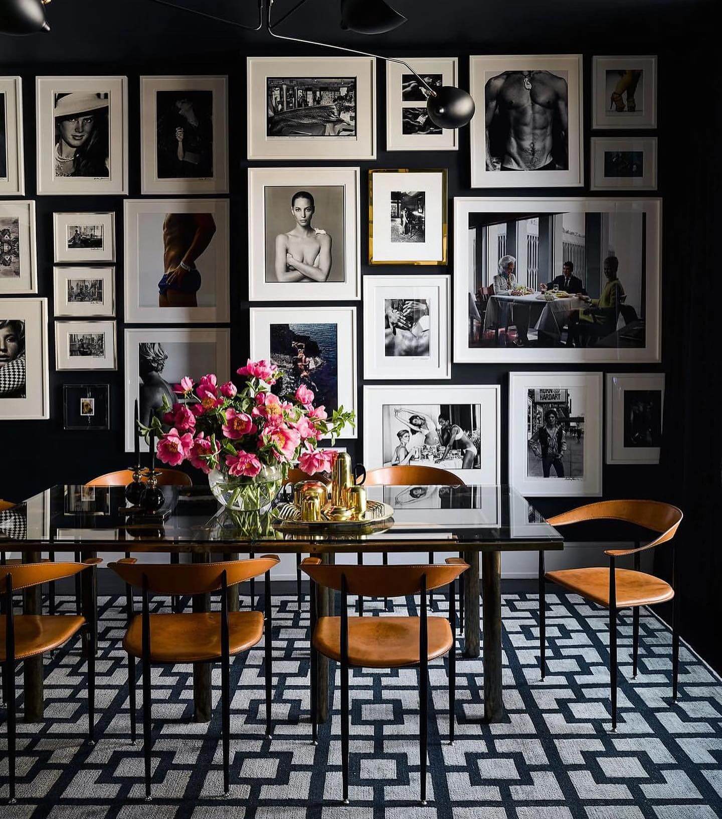 Gallery Wall of Black and White Portraits Creates a Dramatic Backdrop